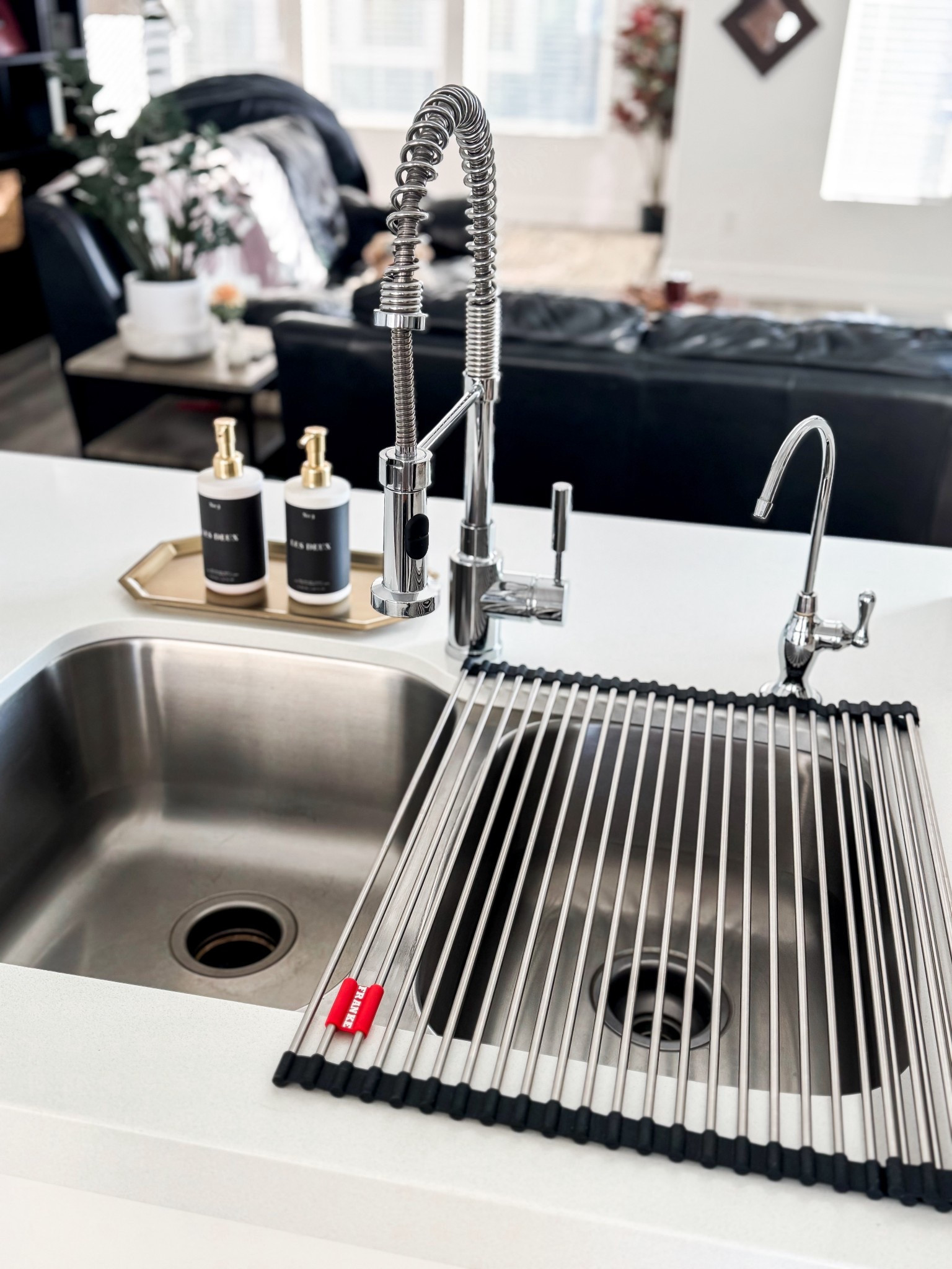 This is one of those quietly genius kitchen finds that instantly makes hosting + everyday prep feel more elevated. The Franke universal stainless steel roller mat rolls right over your sink to create a functional prep station for rinsing produce, air-drying fruits and veggies, draining pasta, or even setting hot dishes straight from the oven.

Made with sleek stainless steel rods and flexible silicone ends, it’s sturdy, heat-resistant, and rolls up neatly when you’re done. Perfect for saving counter space. I love how it keeps everything clean and contained while prepping for guests (or just making dinner feel a little more luxe). Minimal, functional, and looks SO good styled over a farmhouse or modern sink.

Hosting tip: Use it to rinse grapes, berries, and citrus right before guests arrive—everything dries beautifully and stays ready for charcuterie boards or cocktails.

#KitchenFinds #HostingEssentials #LTKHome #KitchenOrganization
#HomeMustHaves #KitchenHacks #ModernFarmhouseKitchen
#HostessLife #EverydayHosting #EntertainingAtHome
#NeutralHome #FunctionalDecor #SinkAccessories
#KitchenUpgrade #HomeDetails #CleanKitchenVibes 

stainless steel sink roller mat • kitchen sink drying rack • fruit and vegetable prep mat • over the sink drying rack
roll up sink mat • kitchen prep accessories • hosting kitchen essentials • modern farmhouse kitchen sink • space saving kitchen tools • luxury kitchen accessories

#LTKGiftGuide #LTKHome #LTKfoodie