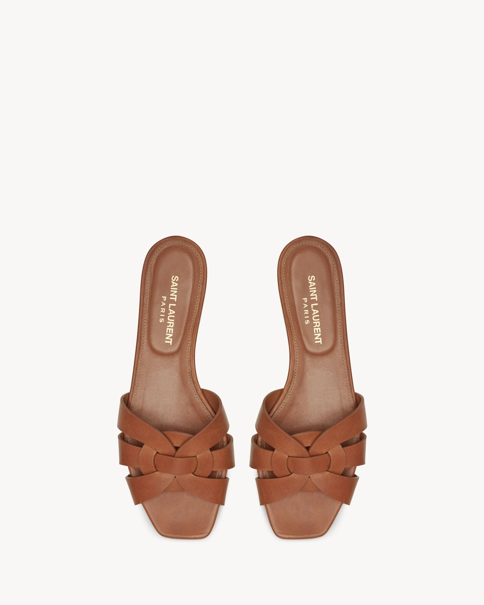 slide sandals made with metal-free tanned leather with intertwining straps. we recommend selectin... | Saint Laurent Inc. (Global)
