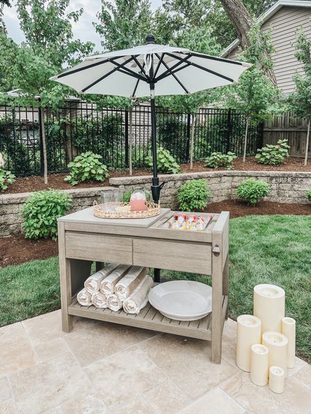 Outdoor Pottery Barn kitchen island with ice bucket, faux outdoor candles and creamy white umbrella

Summer refresh, patio style, outdoor kitchen island, bar cart, outdoor umbrella, neutral pool towel, outdoor candle, Pottery Barn style, outdoor refresh, terracotta bowl, outdoor cooler, umbrella faves, shop the look!

#LTKSeasonal #LTKStyleTip #LTKHome