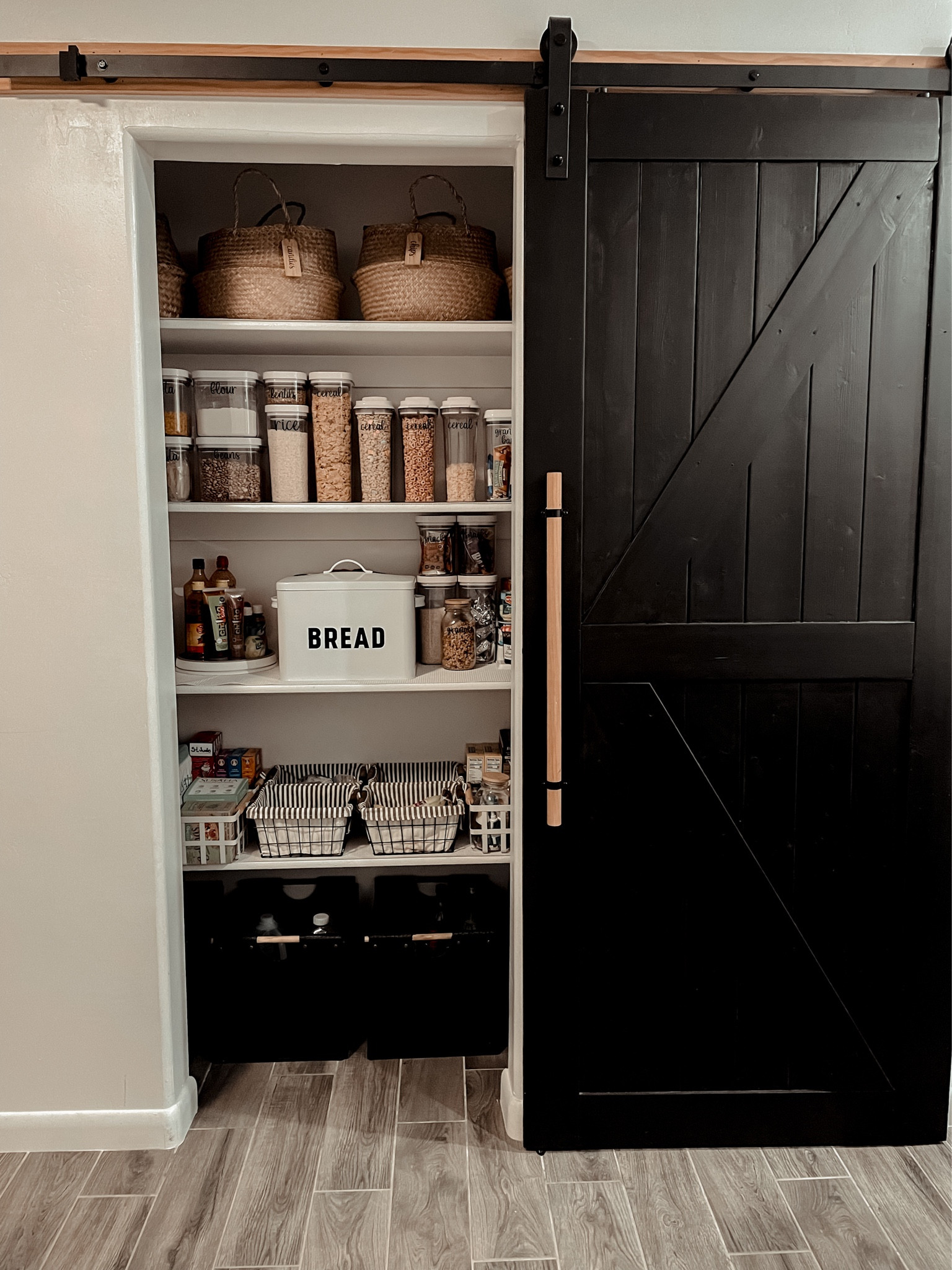 We painted the barn door black and added the wooden rod handle using some bell clamps from a hardware store.

#LTKhome #LTKFind #LTKfamily