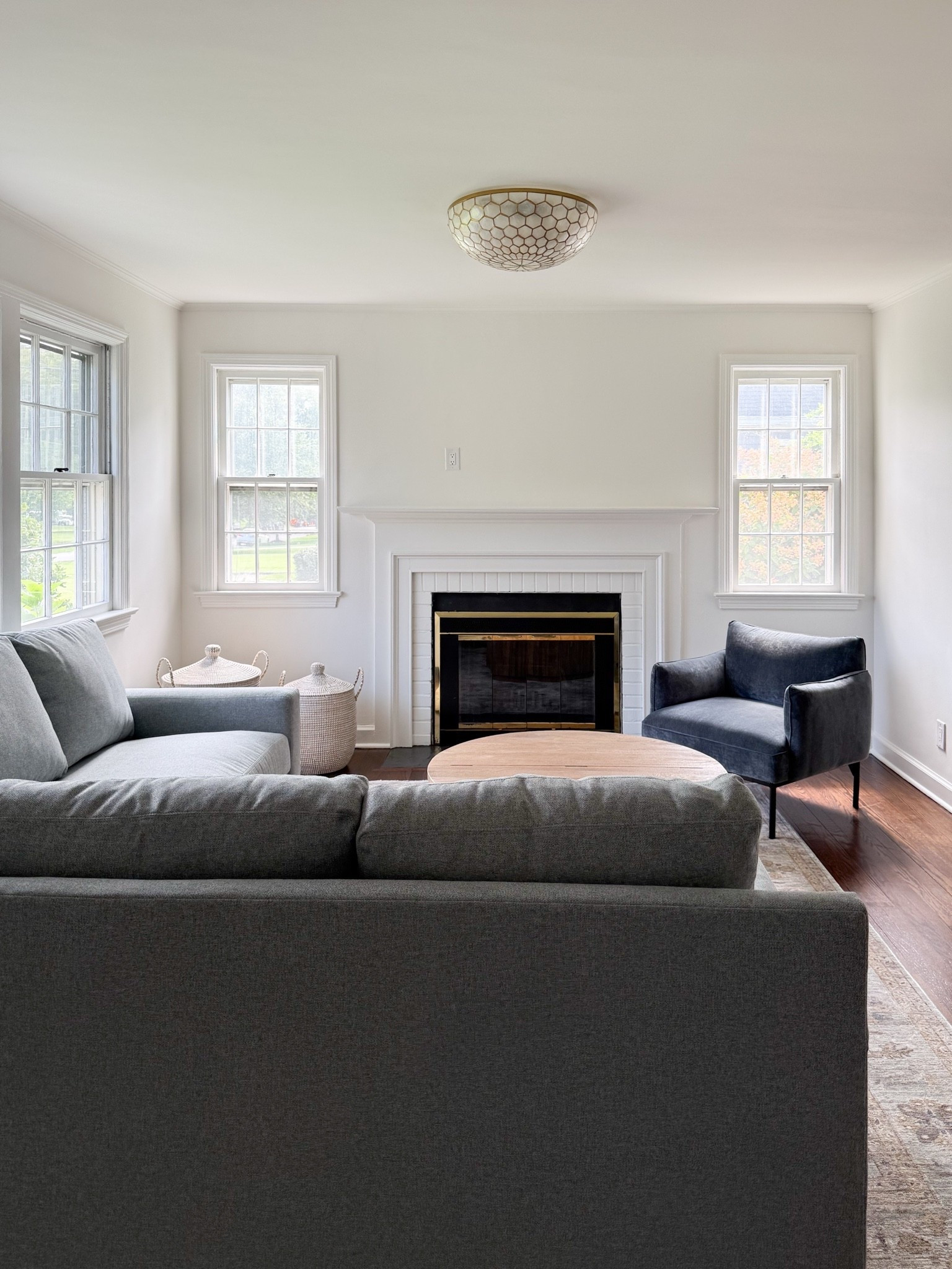 This cozy living room is slowly coming together! The most perfect family-friendly performance sofa, round (storage!!) coffee table, lidded woven baskets for storage, the prettiest pendant light and rug!

#LTKHome #LTKSaleAlert #LTKSeasonal