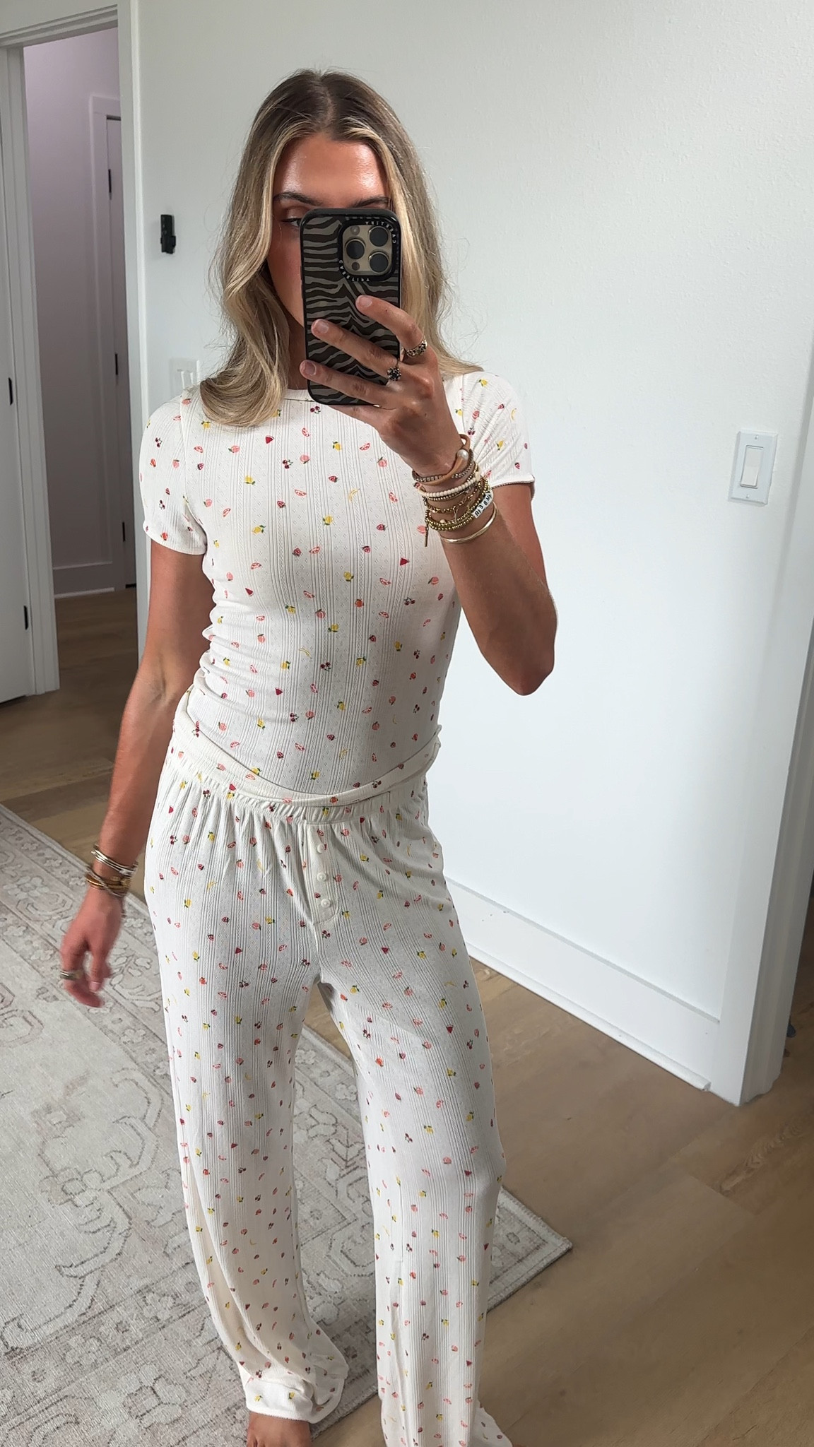 @nuuds size XS The PJ set that earns its luggage space. Lightweight and breathable in a playful pointelle fruit salad print, with scalloped picot trim along the sleeves and waistband for a sweet, feminine finish. The crewneck tee drapes loose, the high-rise pant pulls on easy. Hot sleepers — meet your match.

#LTKootd #LTKSeasonal #LTKmorningroutine