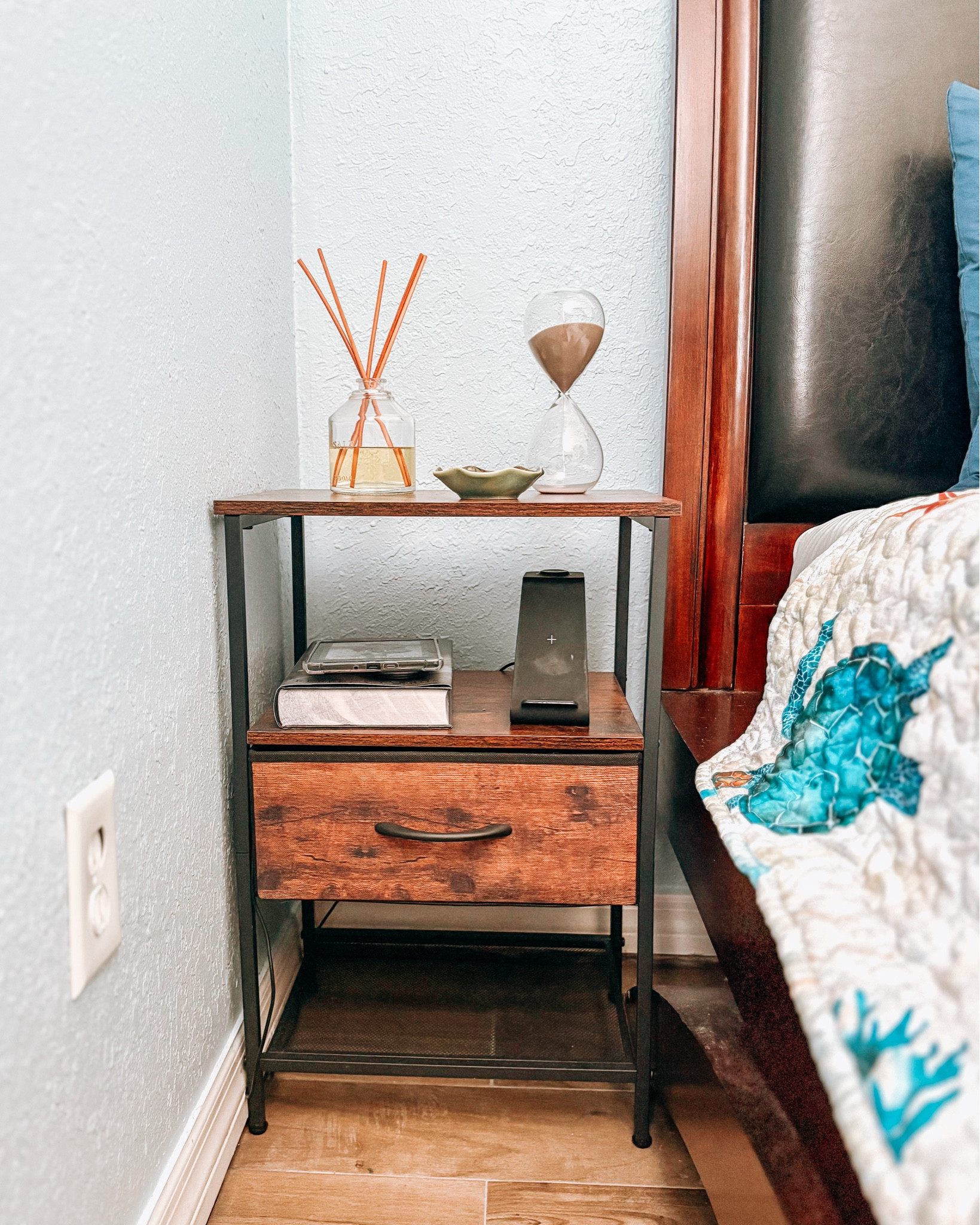 Coastal night stand bedside table decor 🤍🌊🐚 this Amazon nightstand came in a set of two for under $50! I keep my Kindle, a book, charging dock, and jewelry dish on it. It has a drawer that I keep my sleeping mask in as well! I added this hourglass from Hobby Lobby and my Salt scented reef diffuser from Target  

#LTKFindsUnder50 #LTKHome #LTKSaleAlert