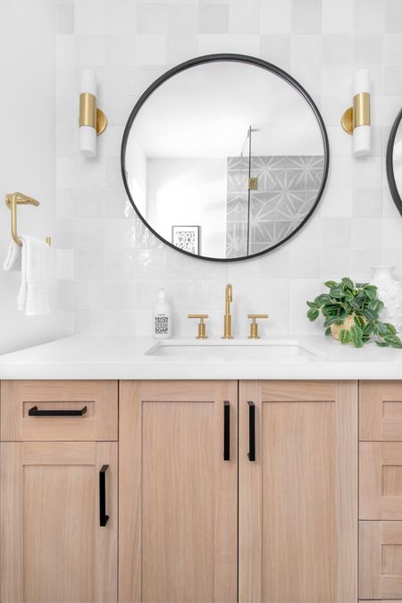 This Palmetto Bay, Florida, underwent a breathtaking coastal modern transformation. We updated the kitchen with a star-patterned honed marble backsplash and complemented it with a Calcutta marble countertop and mixed-metal fixtures and pulls for a bold contrast. In the guest bathroom, we added an oak vanity with geometric floor tile and ceramic glazed wall tiles. The kids' bath got a moody blue vanity and subway tiles. This family and dog-friendly home transformation is nothing short of paradise. #timeless #sophistication #kitchenbanquette #remodel #kitchenremodel #guestbath #kidsbathroom #marblecountertop #mixedmetal #bolddesign #interiordesign #homedesign #customvanity #bluevanity #moodybathroom

#LTKhome