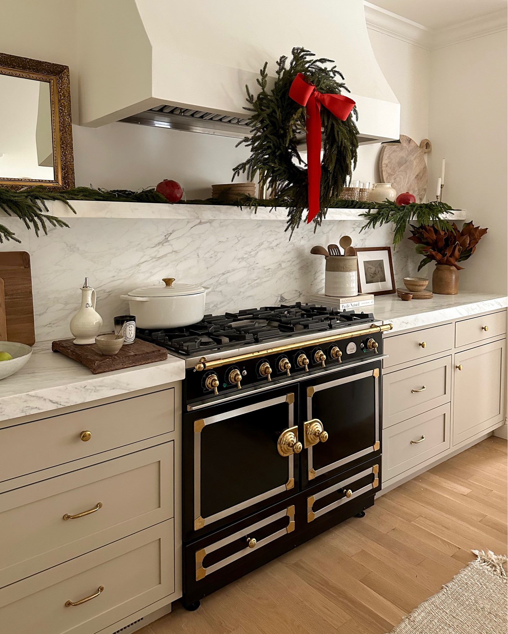 Kat Jamieson shares her festive kitchen. Farmhouse, decor, interiors, wreath, Christmas, pot, pan, stove, oven, cutting board, hardware, cabinets, rug. 

#LTKHoliday #LTKSeasonal #LTKhome