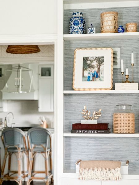 Added some fall warmth to our blue and white bookshelves! Touches off brass, books, rattan, and blue and white pottery  
Also our counter stools are currently on sale! They are my favorite and super family friendly! 

#LTKhome #LTKSeasonal
