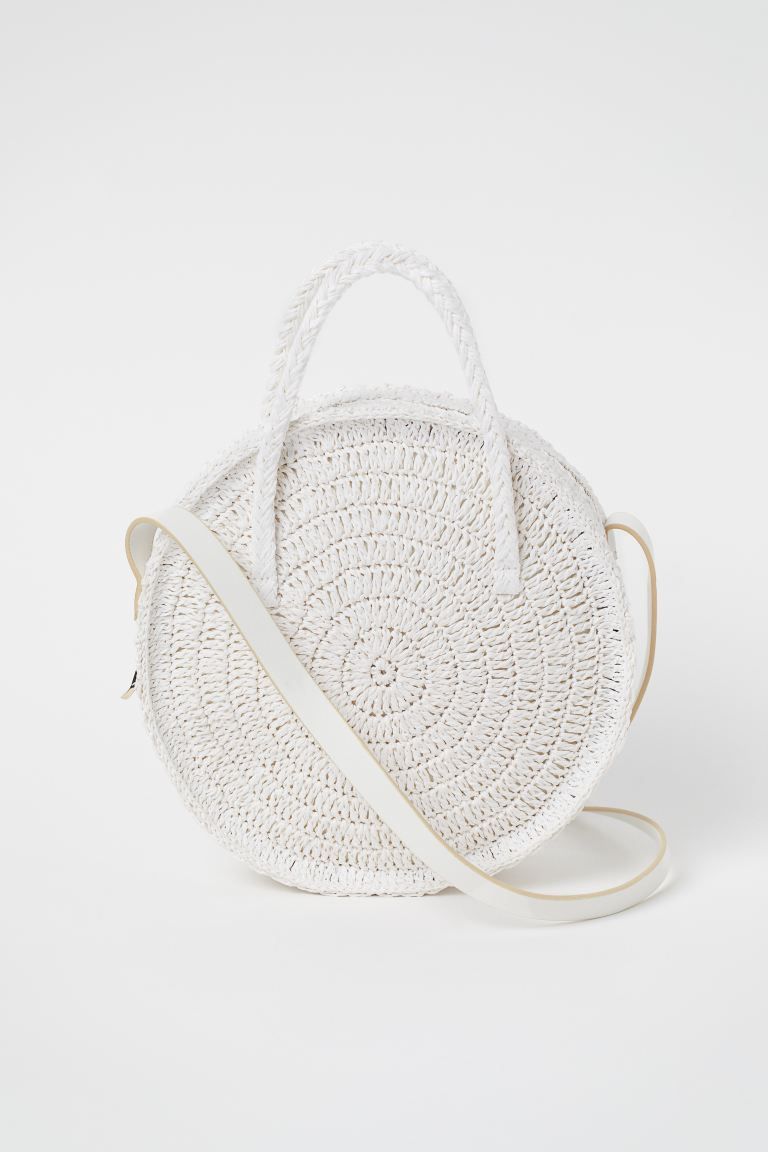 Round shoulder bag in braided paper straw. Narrow shoulder strap in faux leather, two handles, an... | H&M (US + CA)