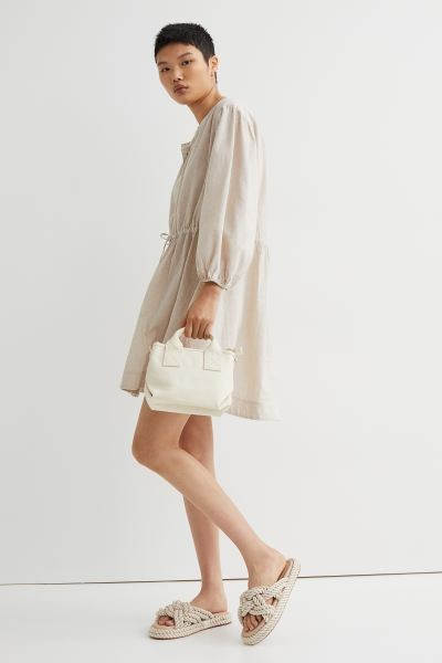 Short dress in a linen and cotton weave with a round neckline, concealed button placket, and yoke... | H&M (UK, MY, IN, SG, PH, TW, HK)