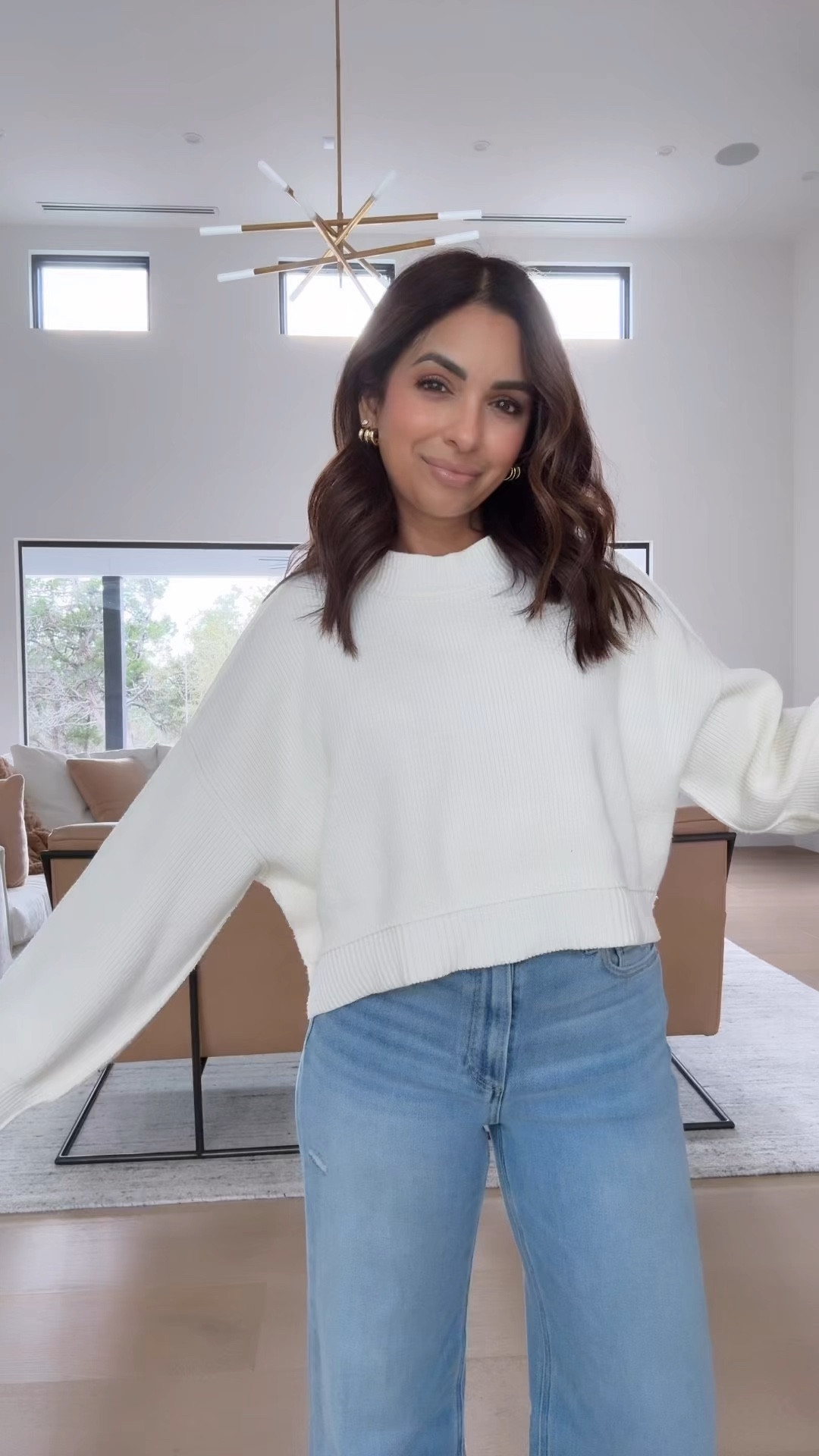 Wearing an xs in free people sweater. This has somewhat of a cropped fit but doesn't show any tummy for me, I wear high waisted jeans and it's perfect. It's such a comfy and flattering fit, runs TTS. I have the XS. If you are worried about length I think going up a size is totally fine also!! 

#LTKSaleAlert #LTKStyleTip #LTKSeasonal