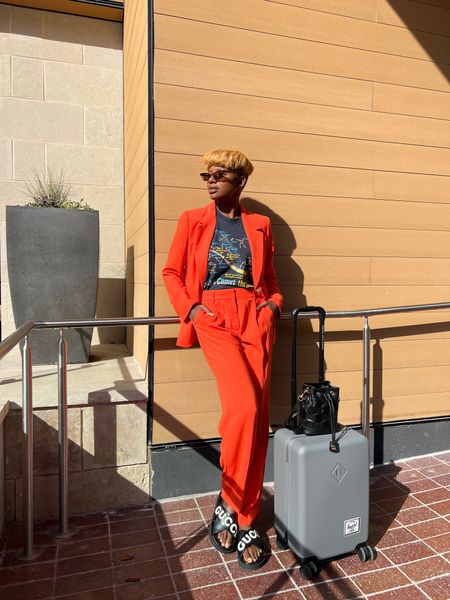 Summer suiting!  Orange crepe suit from J.Crew with black gucci sandals, black Gucci bucket purse, tortoise cat eye sunglasses and grey Hershel carryon luggage  

#LTKunder100 #LTKstyletip #LTKworkwear