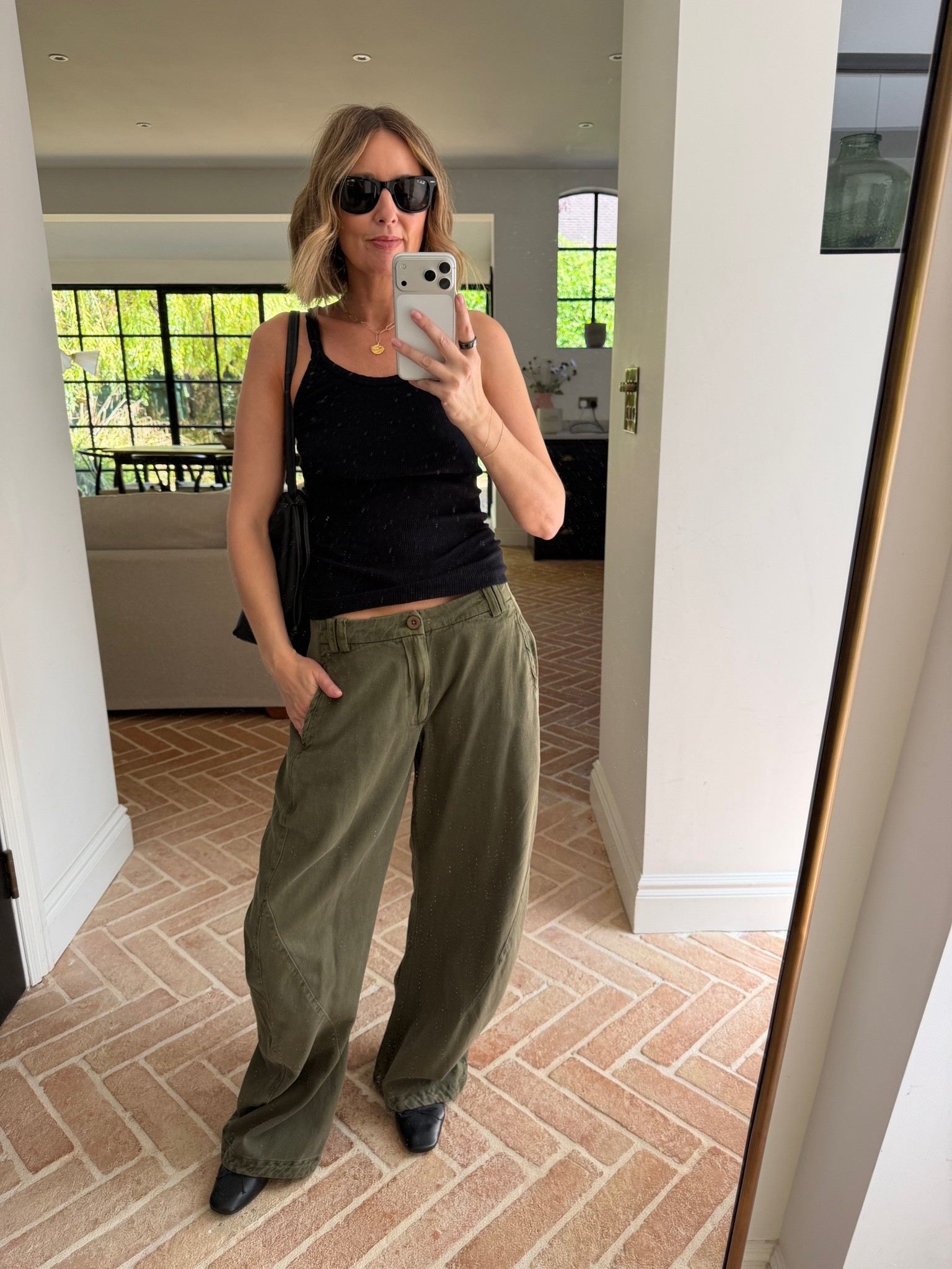 khaki wide leg trousers, olive wide leg pants, army green trousers, utility trousers women, khaki cargo trousers, relaxed fit trousers, black ribbed vest, black tank top, fitted black cami, black and khaki outfit, neutral utility look, black crossbody bag, black shoulder bag, black western boots, black square toe boots, ankle boots outfit, black sunglasses, gold coin necklace, gold pendant necklace, layered gold jewellery, how to style wide leg trousers, khaki trousers outfit, utility fashion trend, casual chic outfit, effortless everyday look, off duty style, mum style, stylish mum outfit, over 40 fashion, ageless style, mirror selfie style, quiet luxury casual

#LTKeurope #LTKfestival #LTKsummer
