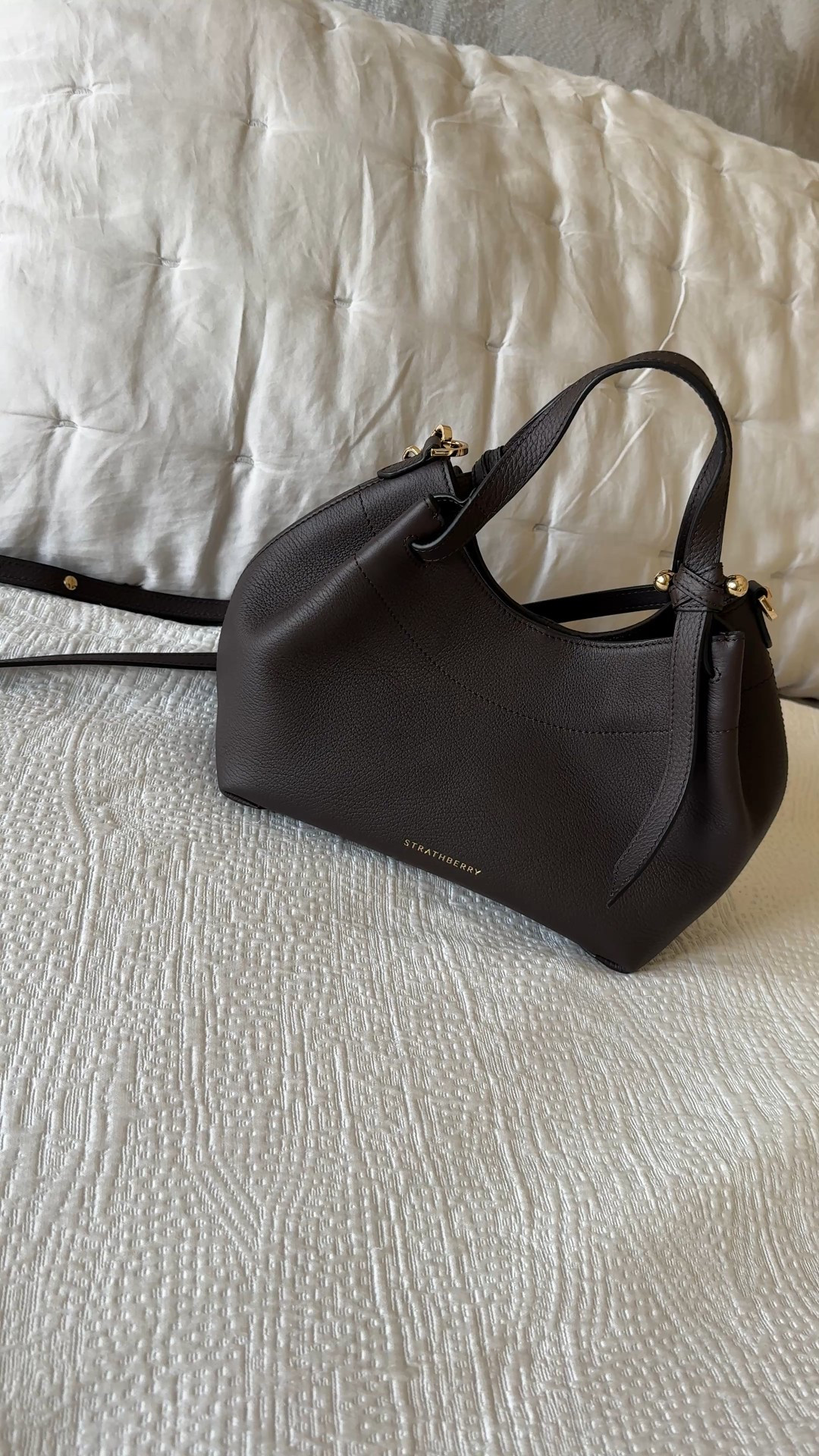 It’s been a while since I fell for a bag. 
And here she is. 
I decided to get myself a nice souvenir on our recent trip to London. I had seen this style online and when I saw her in the flagship store, I couldn’t resist. 
Designed in Scotland and handmade in Spain. 
I shared another Strathberry bag last year and have grown to love the chic minimalist brand. And the materials and quality rival luxury bags that are much more of an investment. 
This exact bag is the mini size; a larger size is also available. The rich dark brown, almost black color drew me in. It is also available in a lighter cognac option. 
If you are one to invest in a good handbag that will last through the years, I highly recommend this brand. 
Linking my favorite styles from their site. 


#LTKOver40