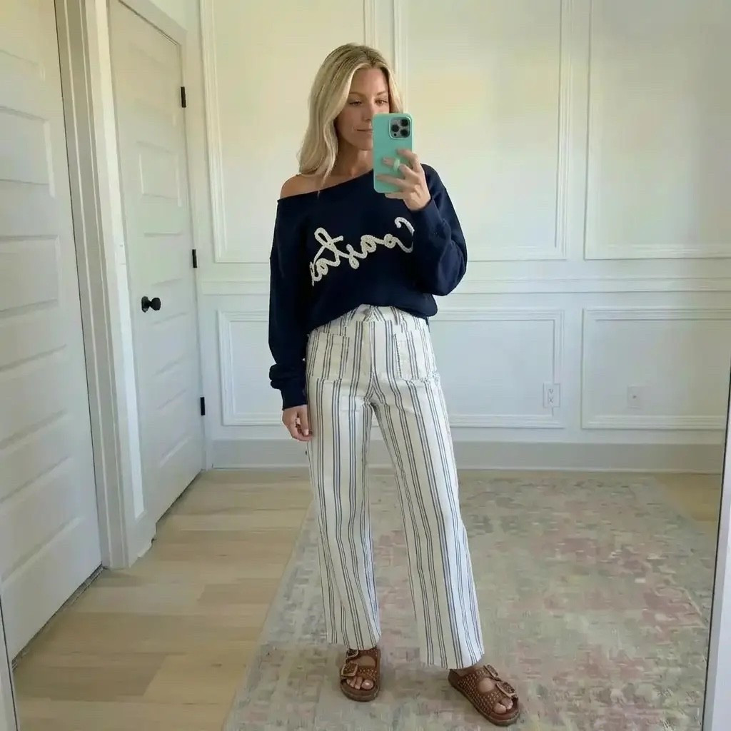 A soft morning glow fills a quiet, sunlit room as she stands effortlessly chic—navy off-the-shoulder knit draped just right, relaxed yet intentional. Crisp striped wide-leg trousers elongate her silhouette, balancing structure with ease, while woven sandals ground the look in casual sophistication. It’s the kind of outfit that feels like a deep exhale: polished without trying, coastal-classic meets everyday confidence. Timeless, unfussy, and quietly powerful—proof that style doesn’t need to shout to be noticed.

Hashtags 📌

#EffortlessStyle
#ClassicWithATwist
#ModernClassic
#EverydayChic
#CoastalVibes
#NeutralStyle
#RelaxedLuxury
#CapsuleWardrobe
#OffDutyStyle
#WideLegPants
#CasualChic
#TimelessFashion
#MinimalStyle
#StyleInspo
#OOTD
#PinterestStyle
#WomenWithStyle
#WeekendLook
#ComfortMeetsStyle
#TrendyHeidi



#LTKValentine #LTKgrwm #LTKdayinmylife