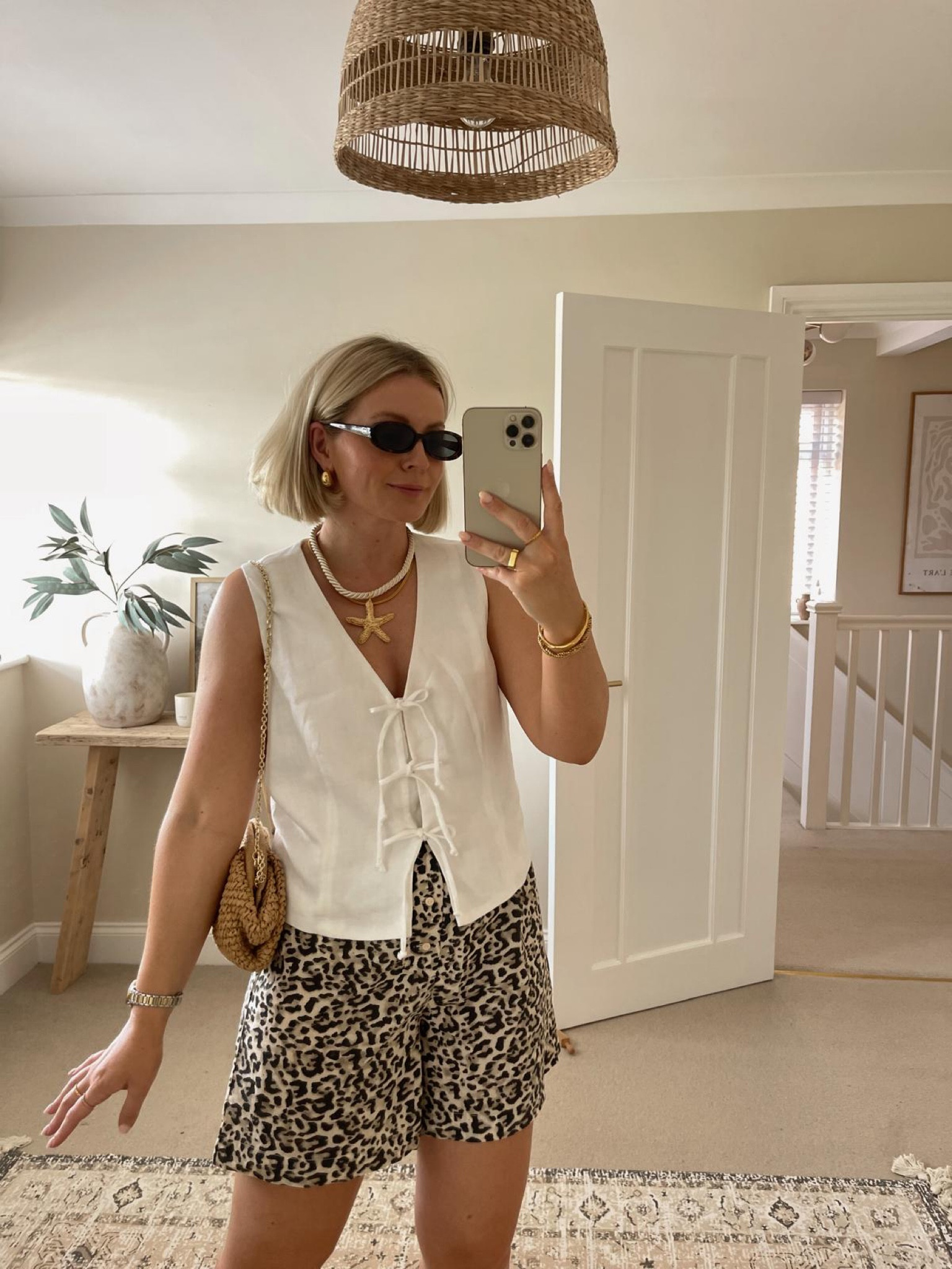 Chic summer festival & Ibiza outfit ideas - white linen tie front waistcoat from mint velvet, asos leopard print shorts, beige suede cowboy boots, mango raffia clutch bag, starfish necklace & Le Specs narrow sunglasses 

#LTKstyletip #LTKuk #LTKsummer