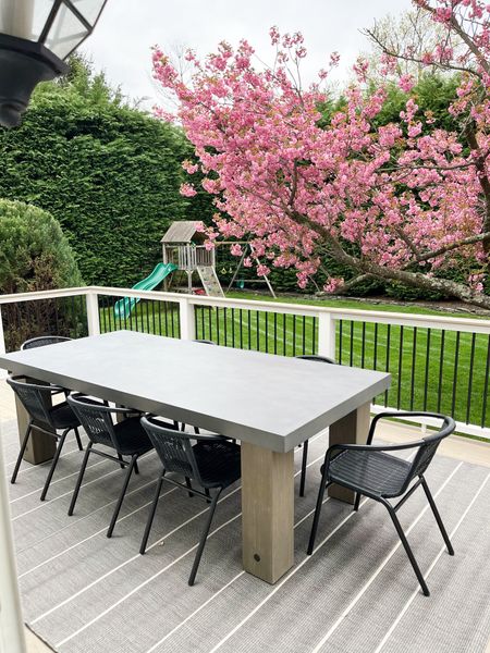 Gorgeous outdoor dining setup! Love the concrete and wood table and this outdoor rug! 

#LTKfindsunder100 #LTKSeasonal #LTKhome