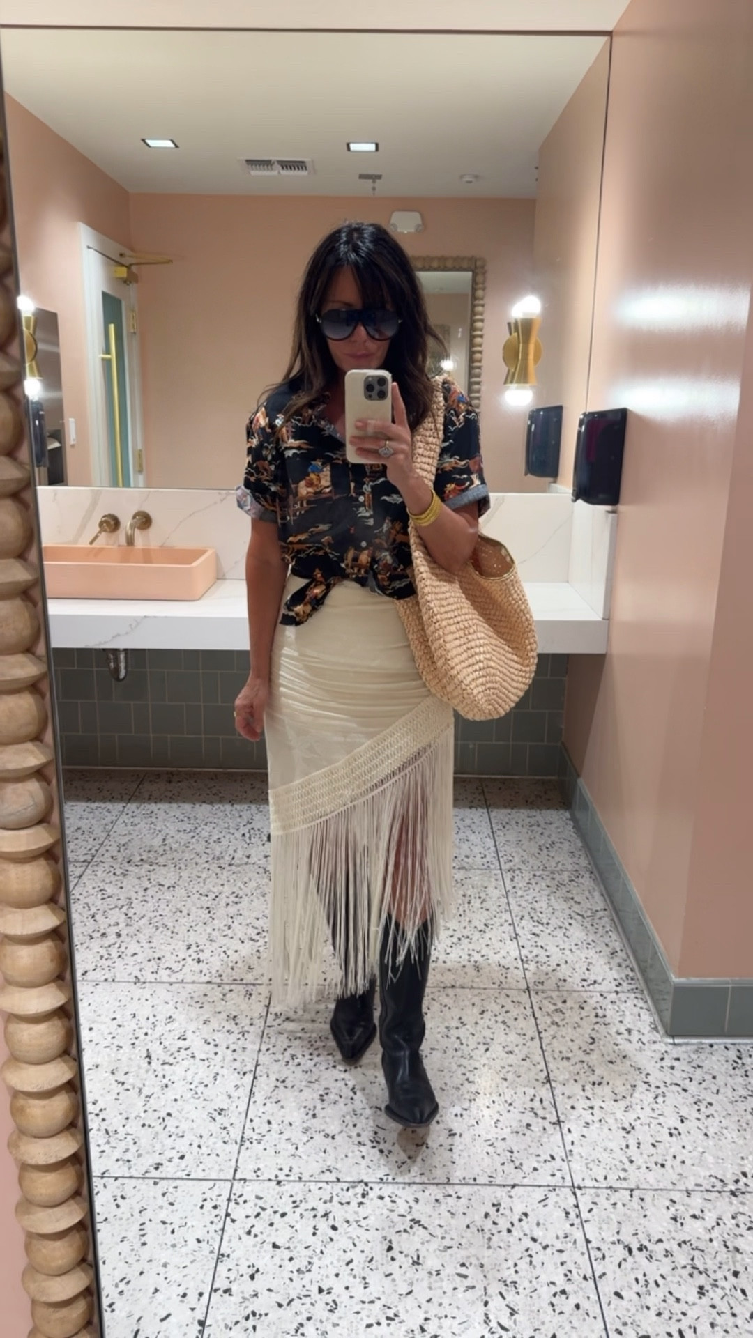 Vintage shirt, fringe skirt is so Coachella under $100 wearing size large in the skirt 
I linked similar boots and my fav summer raffia bag $35

#LTKootd #LTKFestival #LTKOver40