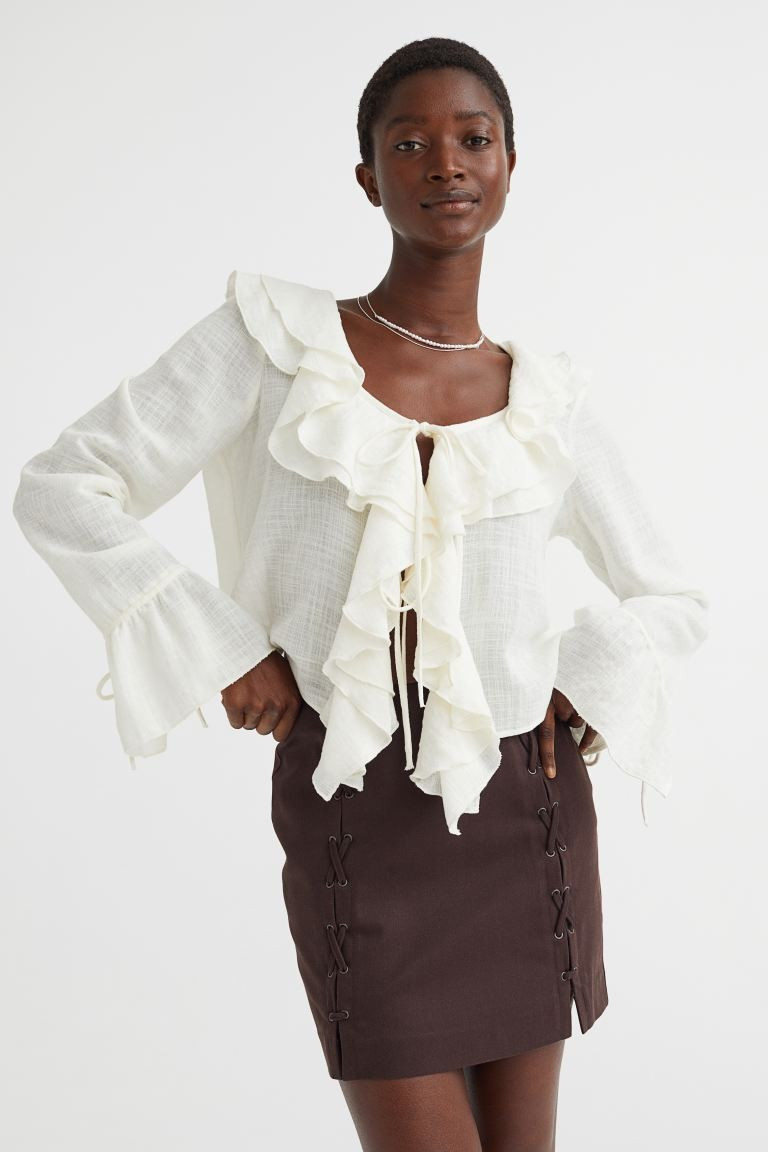 New ArrivalCropped blouse in a woven cotton blend with wide flounces around the neckline and down... | H&M (UK, MY, IN, SG, PH, TW, HK)