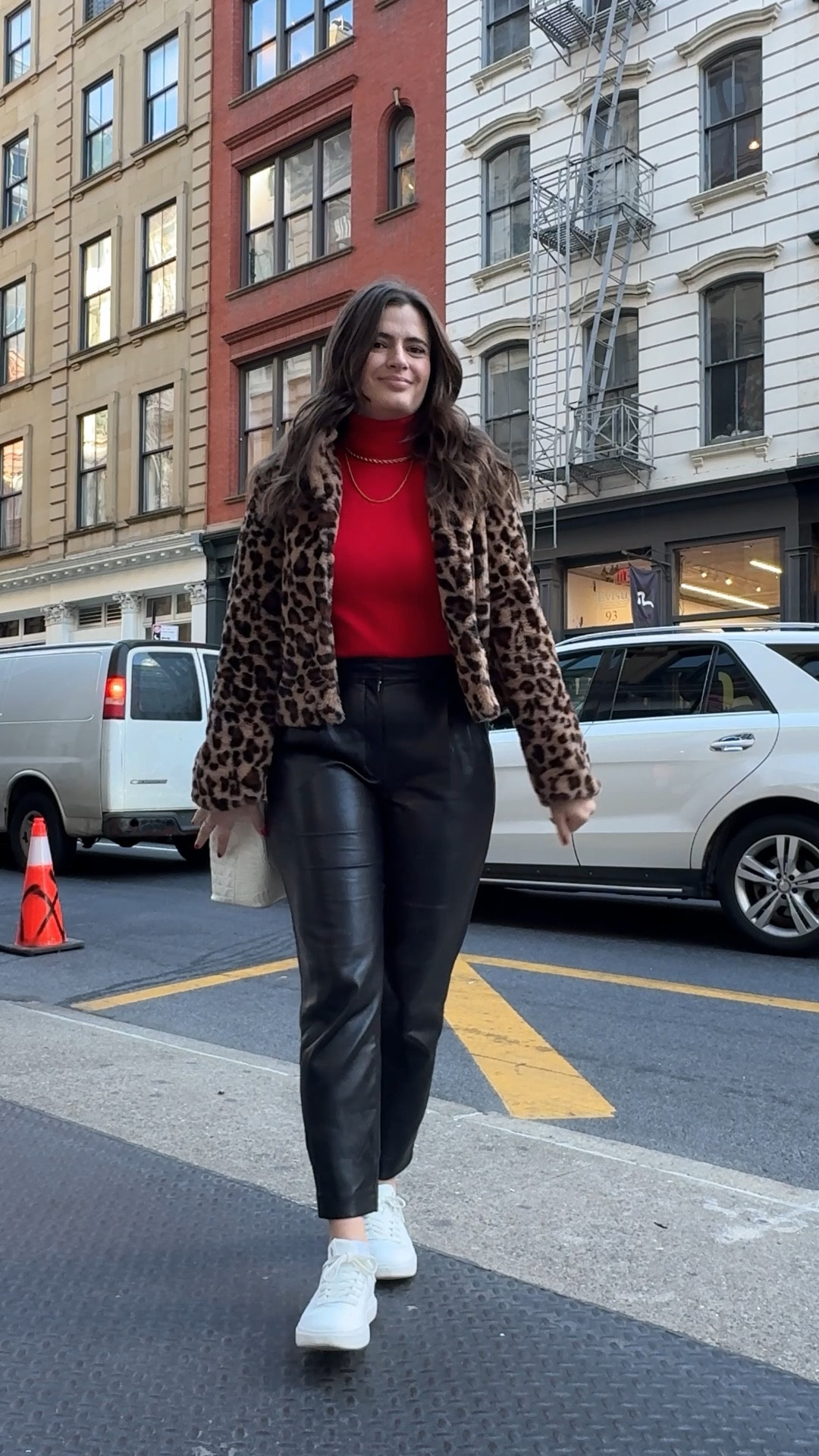 Fall outfit idea leopard cropped faux fur coat, leather pants red turtleneck and sneakers! 