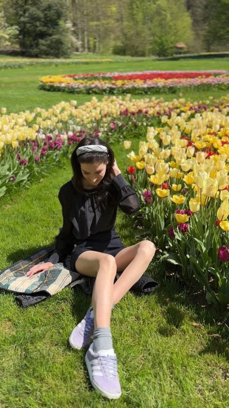 Sunshine, flowers, and a casual date in the botanical garden?  This look is giving all the spring outfit 2024 trends – casual chic with a touch of preppy!  I'm loving the unexpected mix of a luxurious black silk blouse (so comfy!) with these classic Sandro Paris navy shorts. The Barbour jacket adds a layer of effortless cool, while the lavender Adidas Gazelle sneakers keep things playful. A grey sock peeking out adds a fun detail, and the headband is the perfect finishing touch. This outfit is perfect for a walk date in spring!  #springfashion #casualspringoutfit #springoutfits #casualdateoutfit #brunchoutfitspring #casualchicoutfit #LTKspring #LTKsale #dateoutfits #casualoutfits

#LTKVideo #LTKshoecrush #LTKSeasonal