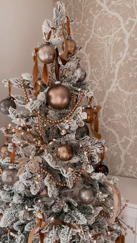 Brass Basket Tree Reveal | I love the beaded garland dupeI found. This 6’ flocked tree is under $100! She’s gorgeous! And the brass basket seen here is actually an end table I flipped over to set my tree in. 

#LTKSeasonal #LTKhome #LTKHoliday