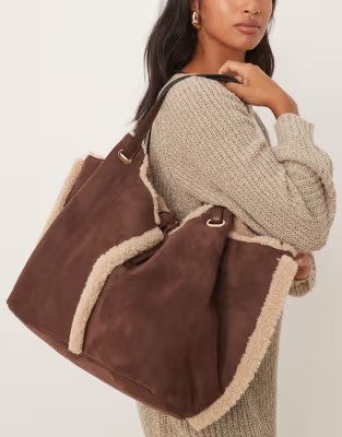 Accessorize shearling and faux suede reversible shoulder bag in brown | ASOS (Global)