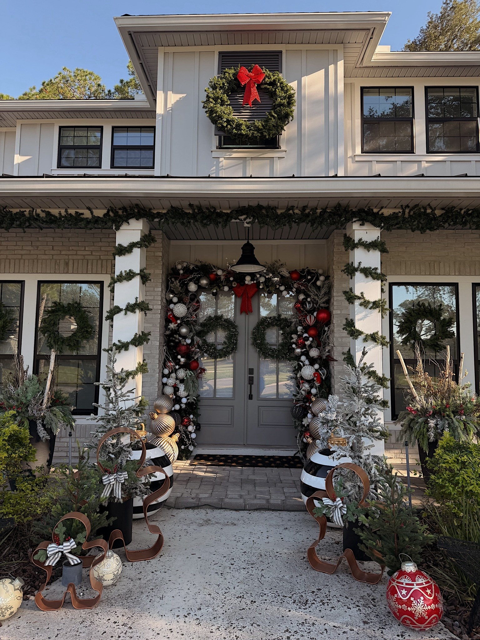 Our Christmas front porch decor! We love to do a dramatic door and pull the decor out to make a grand entrance! 

#LTKHome #LTKHoliday #LTKSeasonal