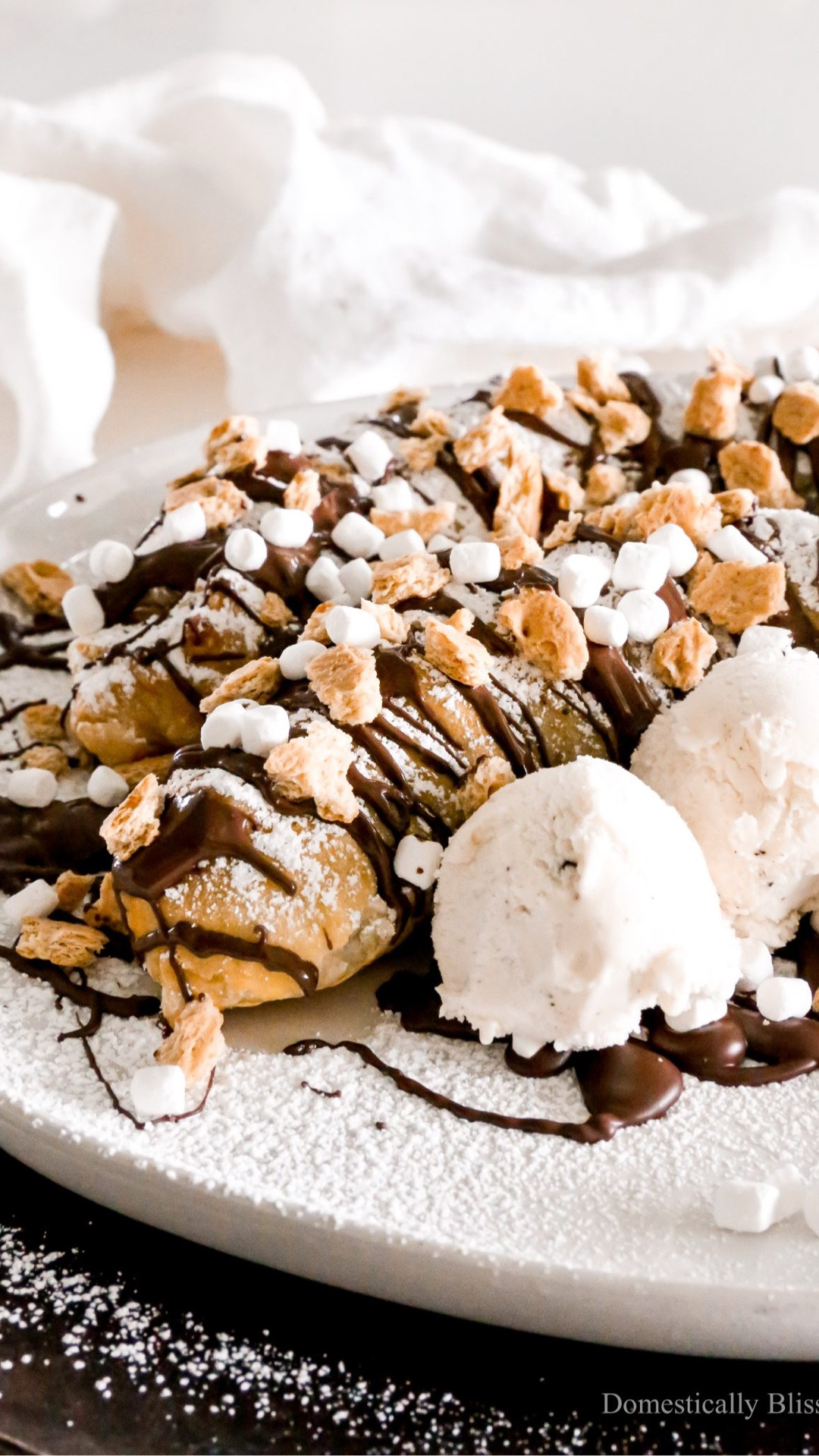 This S’mores Puff Pastry Banana Split is filled with Nutella, chocolate, and marshmallows, wrapped in puff pastry, and topped with powdered sugar, dark chocolate drizzle, crushed graham crackers, and marshmallow bits with a side of ice cream.

See details:
https://domesticallyblissful.com/smores-puff-pastry-banana-split/

#LTKfoodie #LTKSeasonal #LTKKids