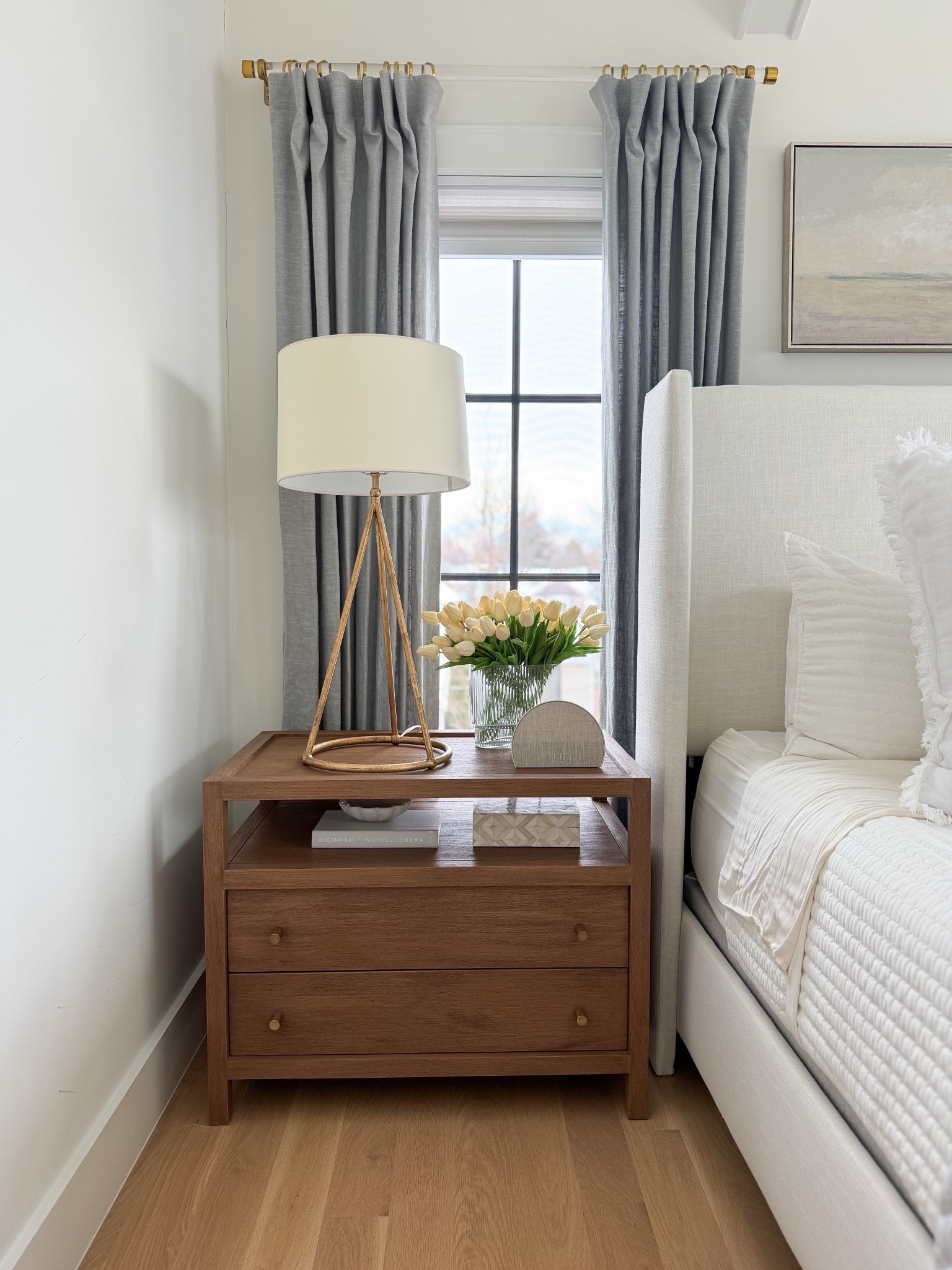 Acrylic and brass curtain rod. Linen curtains in mineral blue. Two drawer wood stand. Traditional brass table lamp. Stand styling. Upholstered bed in Zuma white.

#LTKdayinmylife #LTKHome