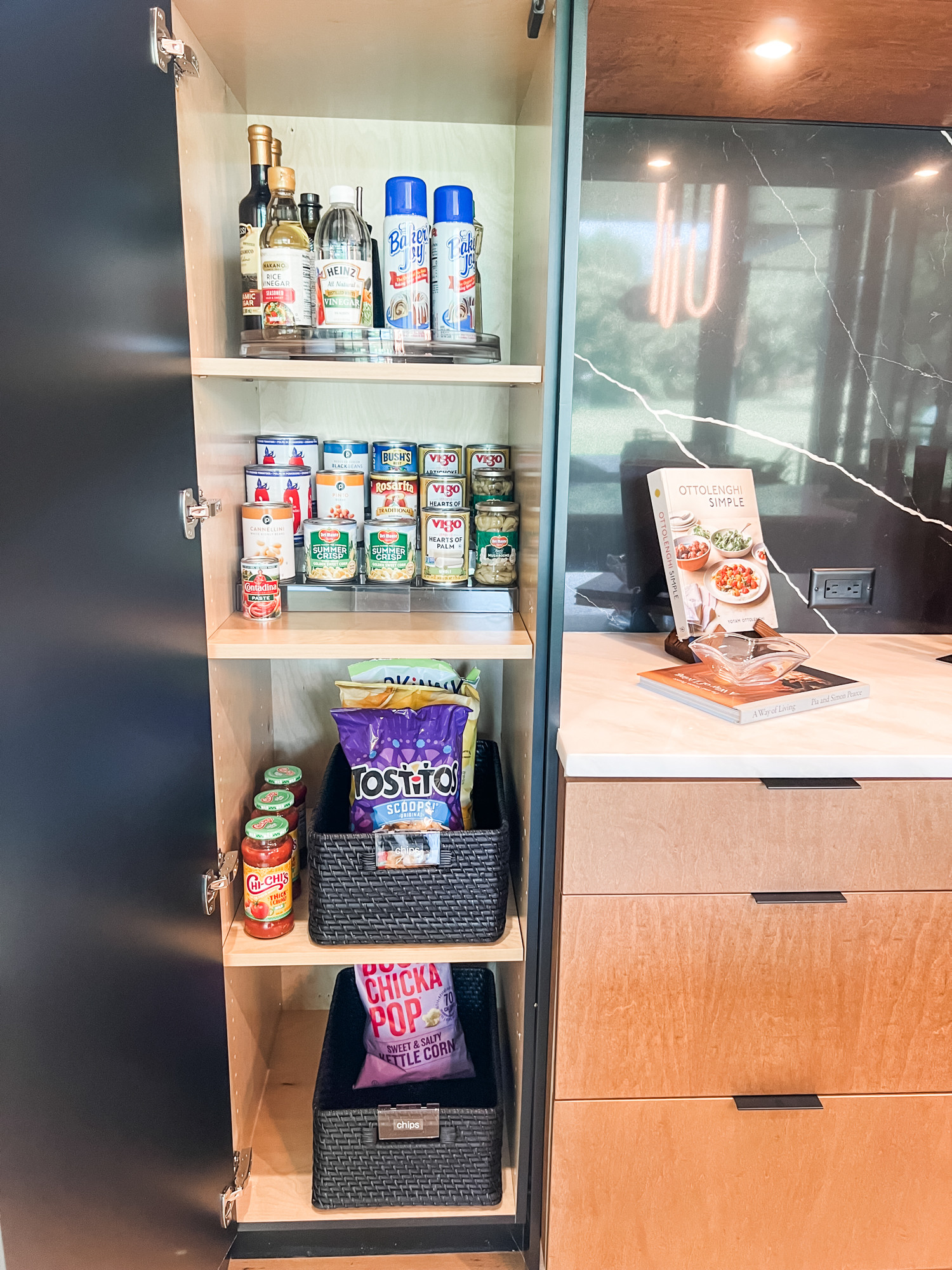 Sometimes these narrow and deep cabinets can become black holes... which is where targeted organization and the right products come into play. Between the turntable, the can riser and the labeled baskets, it's far too hard to pick a favorite part of this kitchen cupboard! 

 
