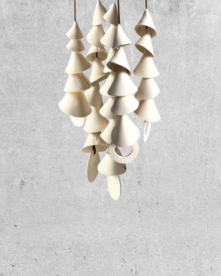 Modern ceramic wind chimes handmade from clay. Sold as singles strands with a long piece of faux leather to hang. Mix or match strands with different numbers of bell chimes.

#LTKSeasonal #LTKfindsunder100 #LTKhome