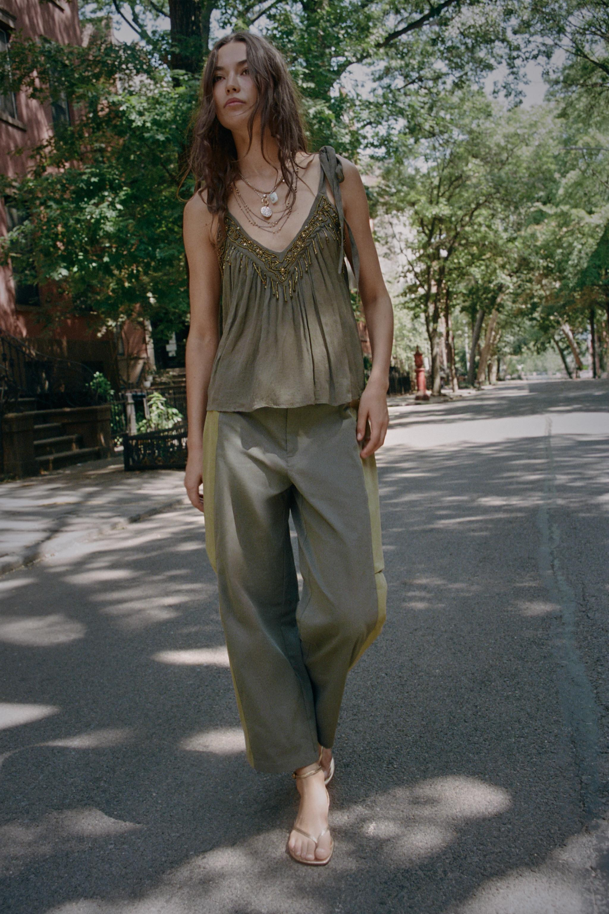 Mid-rise trousers with adjustable front buckles. Features combined side fabric with darts. Loose ... | Zara US