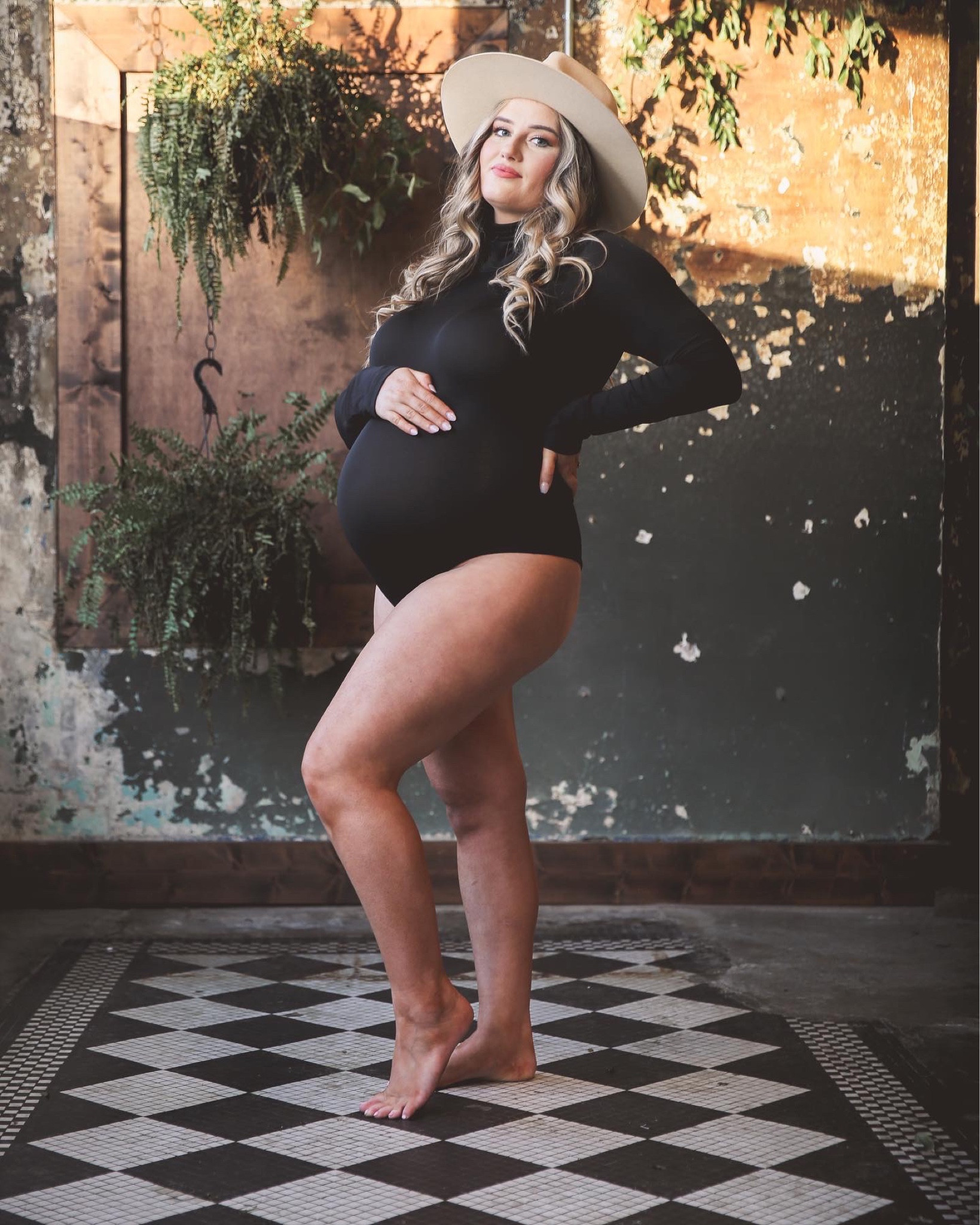 Maternity photo shoot bodysuit silhouette pictures wide tan hat 