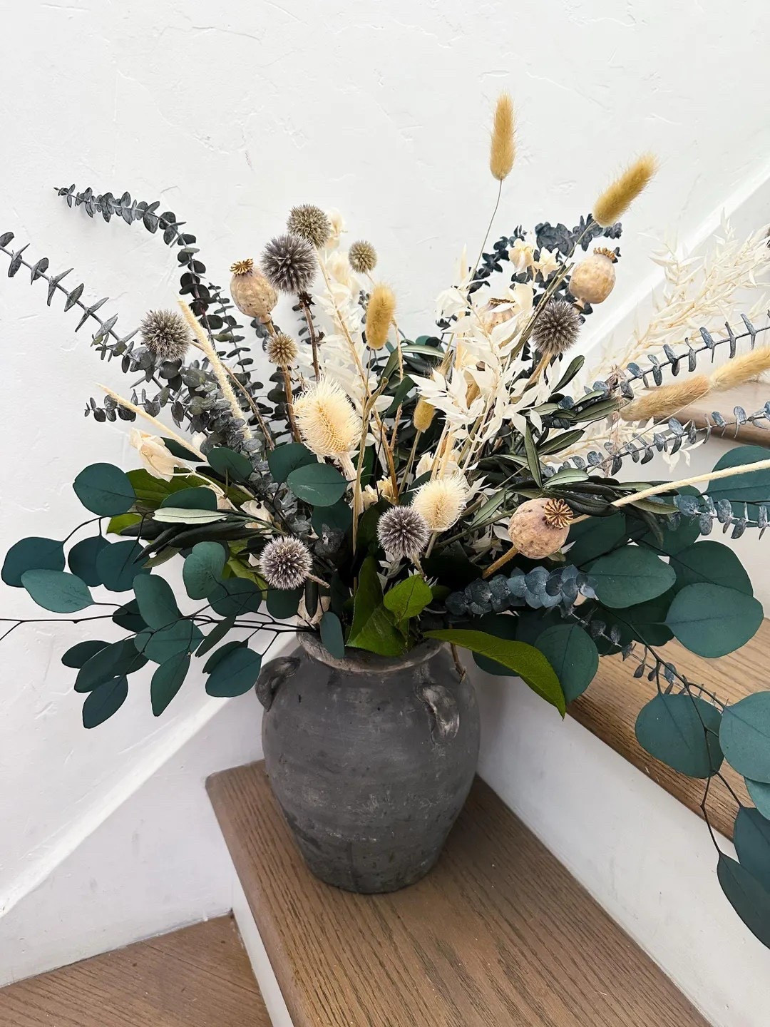 Bring natural texture and neutral beauty into your home with this dried and preserved floral arrangement featuring ruscus, eucalyptus, bunny tails, and thistle. Designed to add effortless elegance, this long-lasting arrangement requires no water and stays beautiful for years, making it perfect for coffee tables, entryways, or home staging. The soft, organic tones blend seamlessly with farmhouse, modern, and minimalist décor styles while adding warmth and dimension to any space.

#LTKHome #DriedFlowers #PreservedFlowers #NeutralDecor #FarmhouseDecor #HomeDecorIdeas #NaturalHomeDecor #MinimalistDecor #BohoHome #CoffeeTableDecor #InteriorStyling #LongLastingDecor #HomeInspiration #LTKFinds #TimelessDecor 

#LTKFestival #LTKSeasonal #LTKHome
