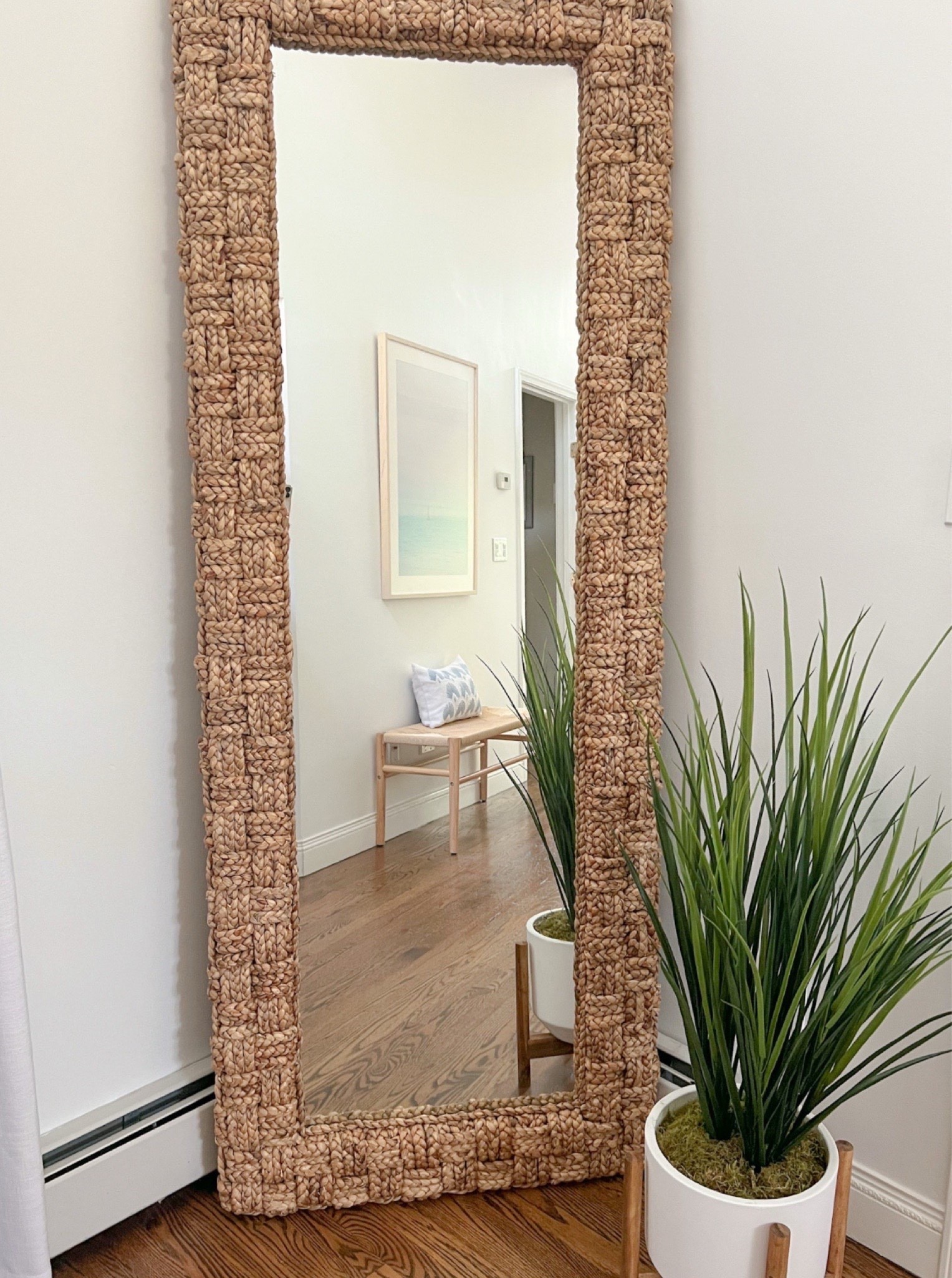 This floor mirror was definitely a splurge for me, but with cathedral ceilings in our primary bedroom I needed a substantial mirror for the correct scale. The quality is top-notch (and quite heavy)! 
------ 
Coastal home decor, coastal style, primary bedroom decor, coastal bedroom ideas, coastal mirror, woven floor length mirror, neutral home decor, neutral mirror, beach house mirror, beach house bedroom decor, beach home style, coastal decorating, coastal interiors, indoor entryway bench, wood floor mirror, primary bedroom decor, coastal mirrors, woven mirrors, statement mirrors, coastal floor mirror, large floor mirror, wayfair mirror, serena and lily look for less, Water Hyacinth mirror, beach house bedroom, framed mirrors

#LTKHome