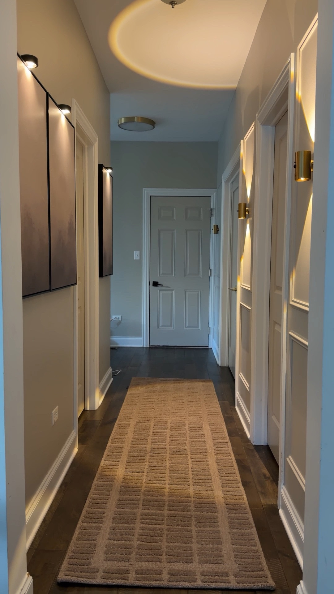 From builder basic to warm & collected 🤎✨ Proof that even the smallest spaces deserve a little intention. Added molding, oversized art, a cozy runner, and rechargeable lighting no hardwiring needed 🙌🏼 The lighting completely changed the mood and made this hallway finally feel like part of the home. ✨

#LTKHome