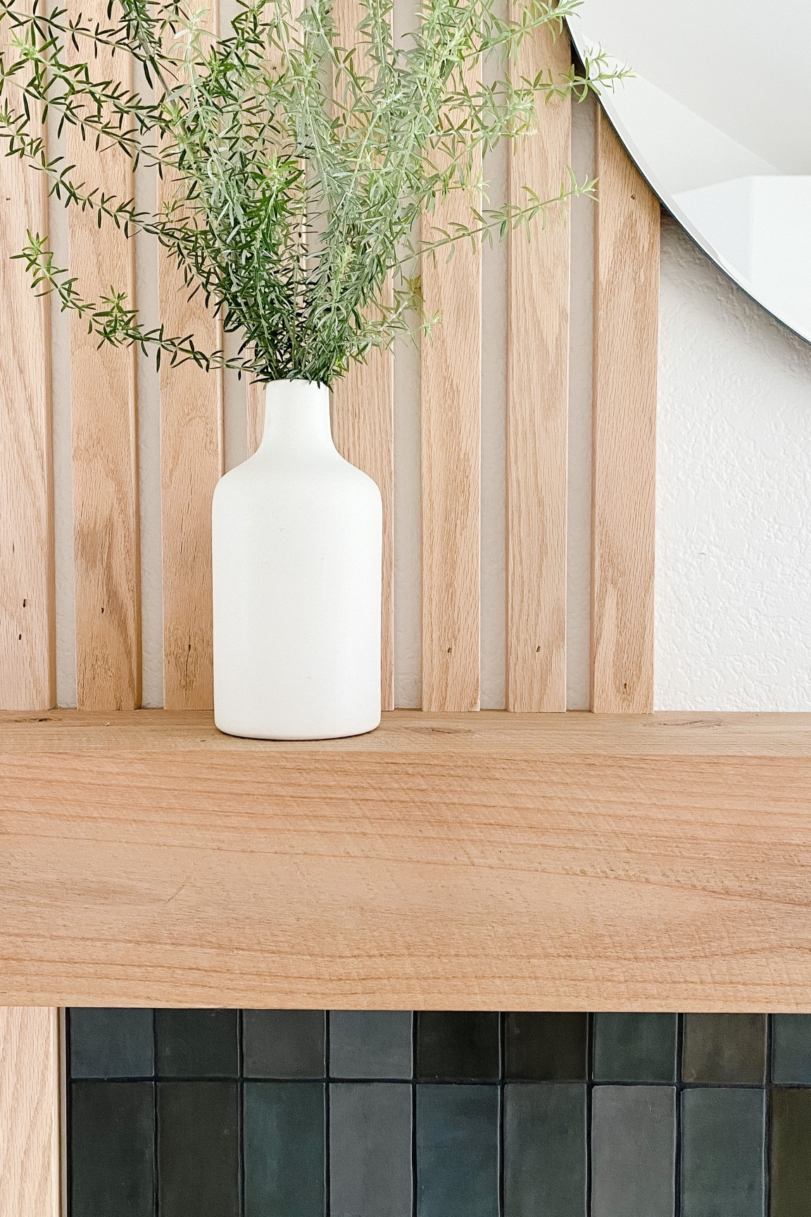 Fireplace but make it a statement. Fire mantle, mirror, vase, wood paneling, tile, home decor. 

#LTKhome #LTKunder100