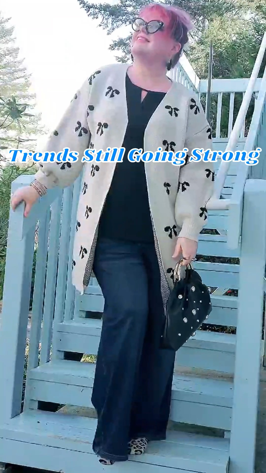Multiple trends are still holding strong: bow print, studs on bags and shoes, leopard print everything, and perennial Classics like wide leg denim. 💖The key to combining multiple trends at one time is to use neutral tones so they all work together without fighting each other or looking clownish.
🌟 if you want this exact sweater, which comes in four different colors and goes up to size 5X, head over to my TT account, I’ve got it linked in my showcase.
👇🏼Click through below to grab your sizes before they sell out, and to get in on great sales this weekend!

For reference, I’m 5‘9“ tall, usually wear a 2X on top, XL – 18 on bottoms, size 10 shoe. Here I’m wearing an 18–20 in the black top, size 1X in the wide leg pants (although I could go a size smaller bc they have an elastic waist), size 2X/16 in the sweater, although probably could’ve gone a size up so that it closed more easily in the front, size 10 shoe.

#LTKMidsize #LTKTall #LTKPetite #LTKWorkwear

#LTKOver40 #LTKPlusSize #LTKootd