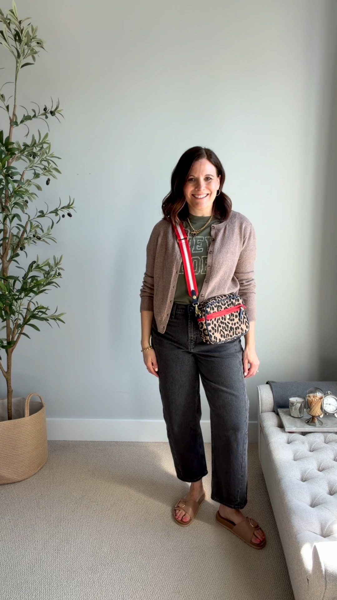 Barrel jeans are super trendy and modern. This is my favorite pair (Old Navy, fit tts) for its slimmer, curved leg, which creates a more fitted and wearable style that adds minimal visual weight. While initially I was one the fence about them, in the right pair, I love their edgy, laid-back vibe. I’m playing that up by pairing them with this olive green “New York” graphic tee (size down, in an XS), one strap sandals, and this tan cardigan. The leopard bag adds a fun pop of color to the outfit. This bag is from Boden a few seasons back, similar options are linked.

#LTKMidsize #LTKOver40 #LTKSaleAlert