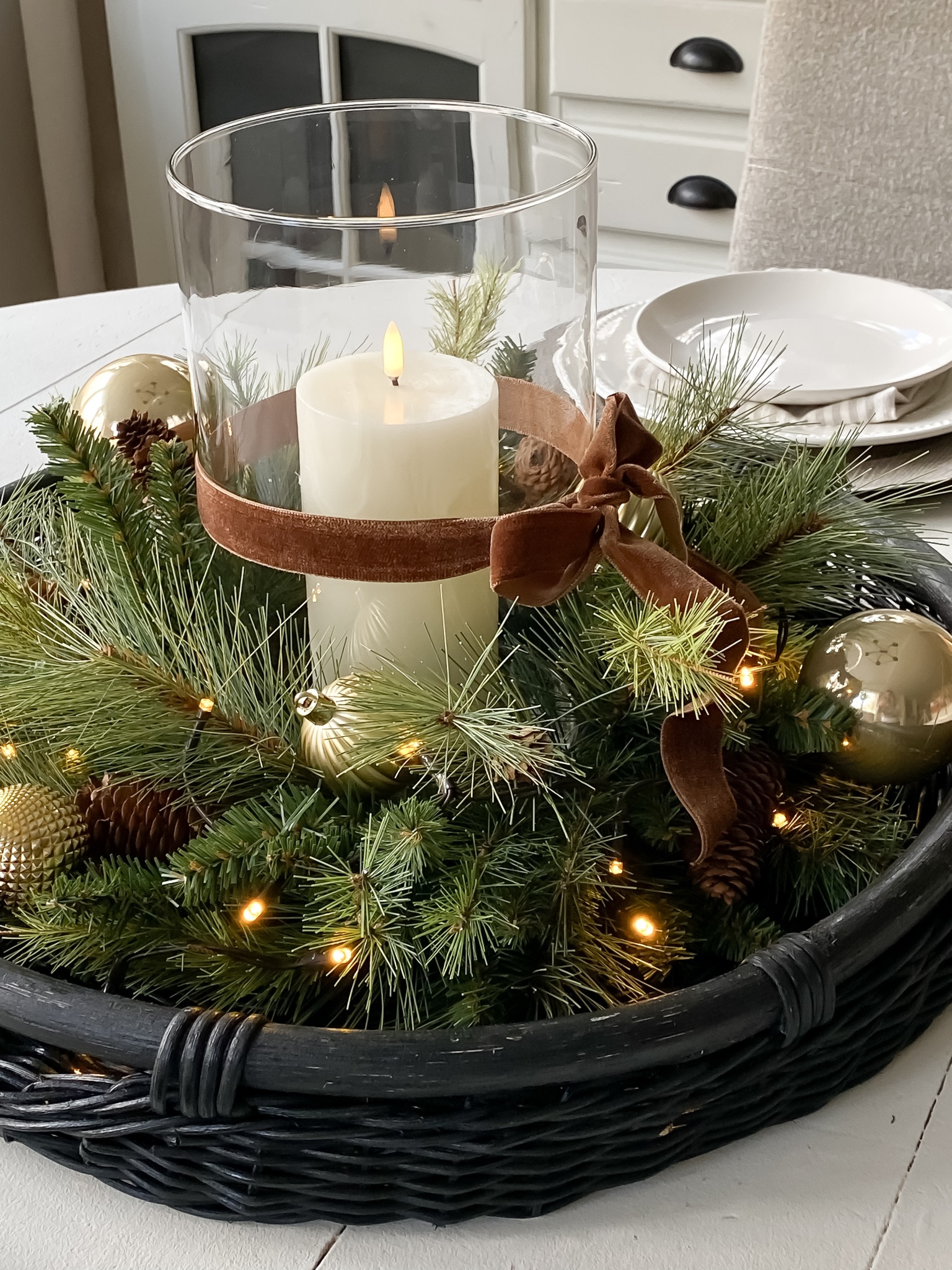 Holiday centerpiece. 
Glass vase, ribbon and battery operated twinkle lights from Hobby Lobby. 