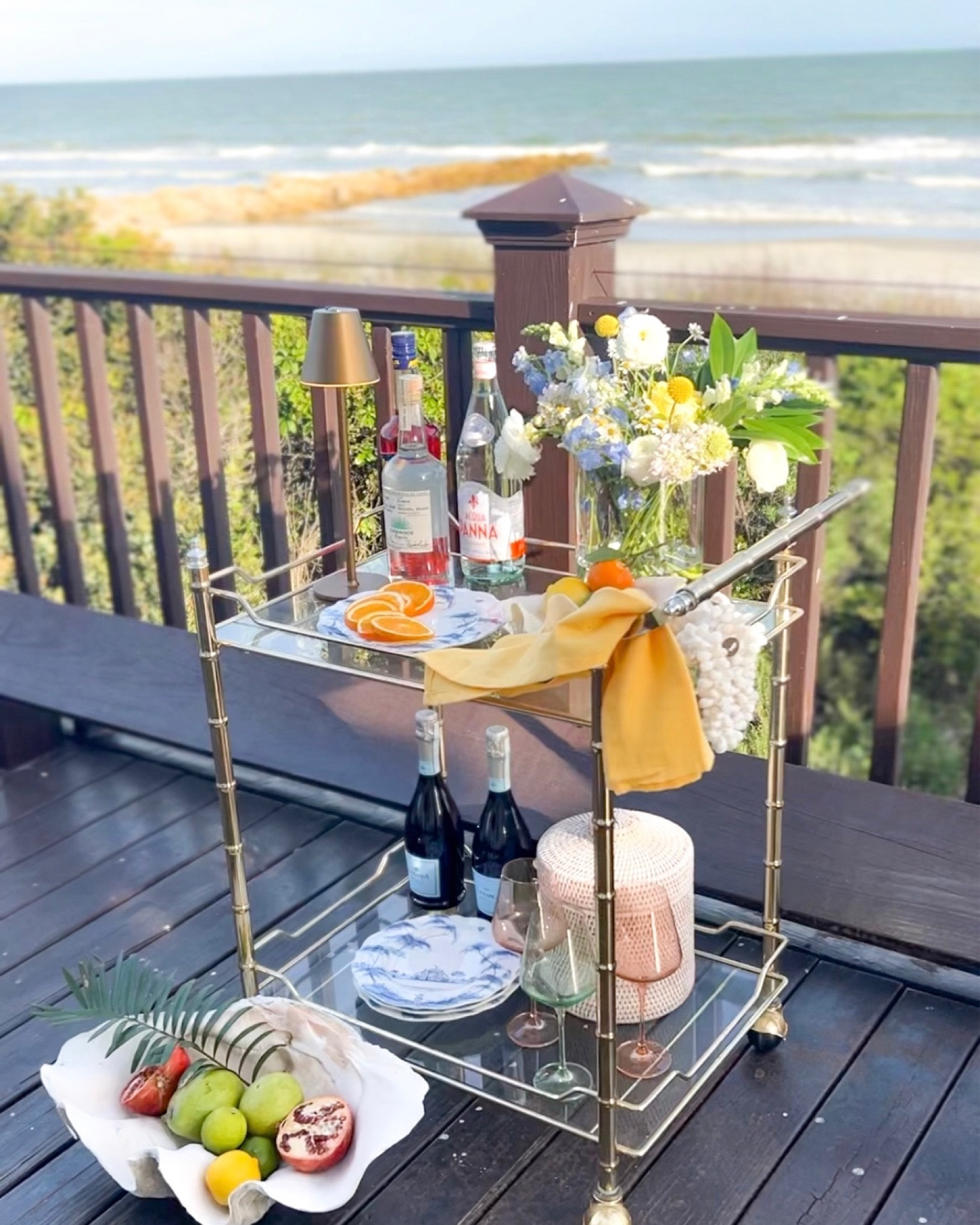 Coastal Bar Cart! Gold bar cart, bamboo bar cart, serving cart, blue and white china plates, rattan woven ice bucket, whicker ice bucket, large clam shell bowl, barware, table light

#LTKhome #LTKunder100