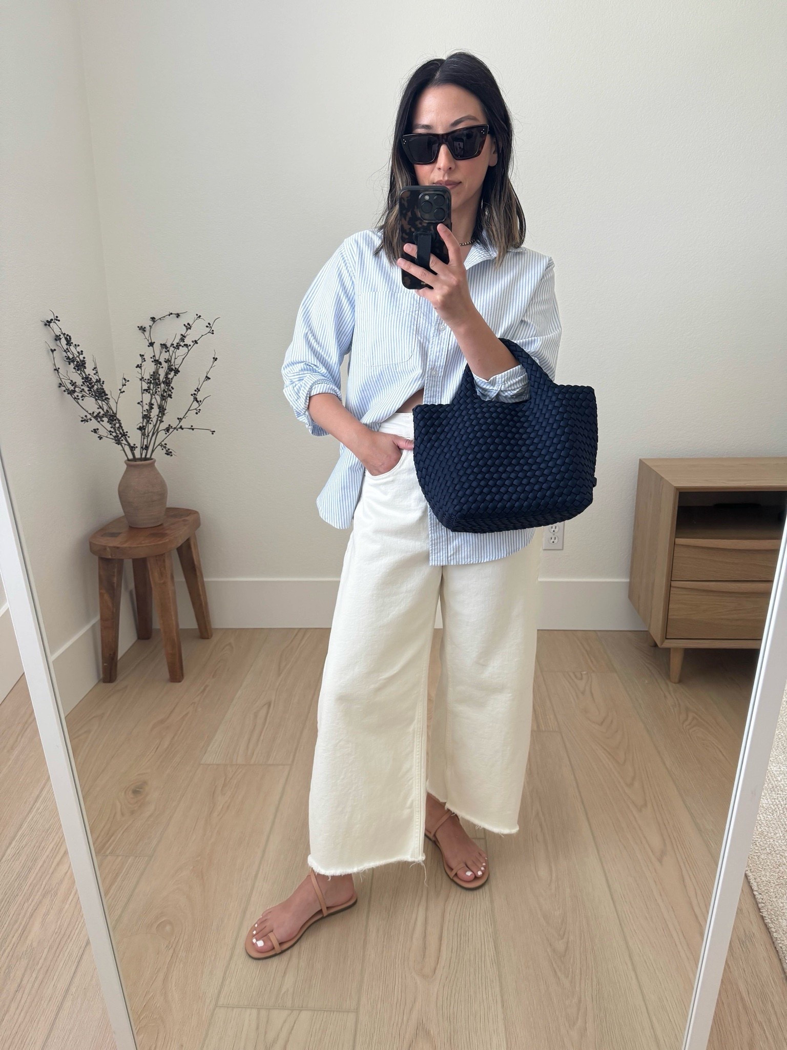 My favorite Everlane curve jeans. Exaggerated for sure but they’re so good! I sized up 2 sizes for comfort. Very high rise. Cut the hems. 

Everlane shirt 4
Everlane jeans 26. Cut hems 
Tkees sandals 5
Naghedi mini navy 
Celine sunglasses 

Petite style, jeans, summer style 