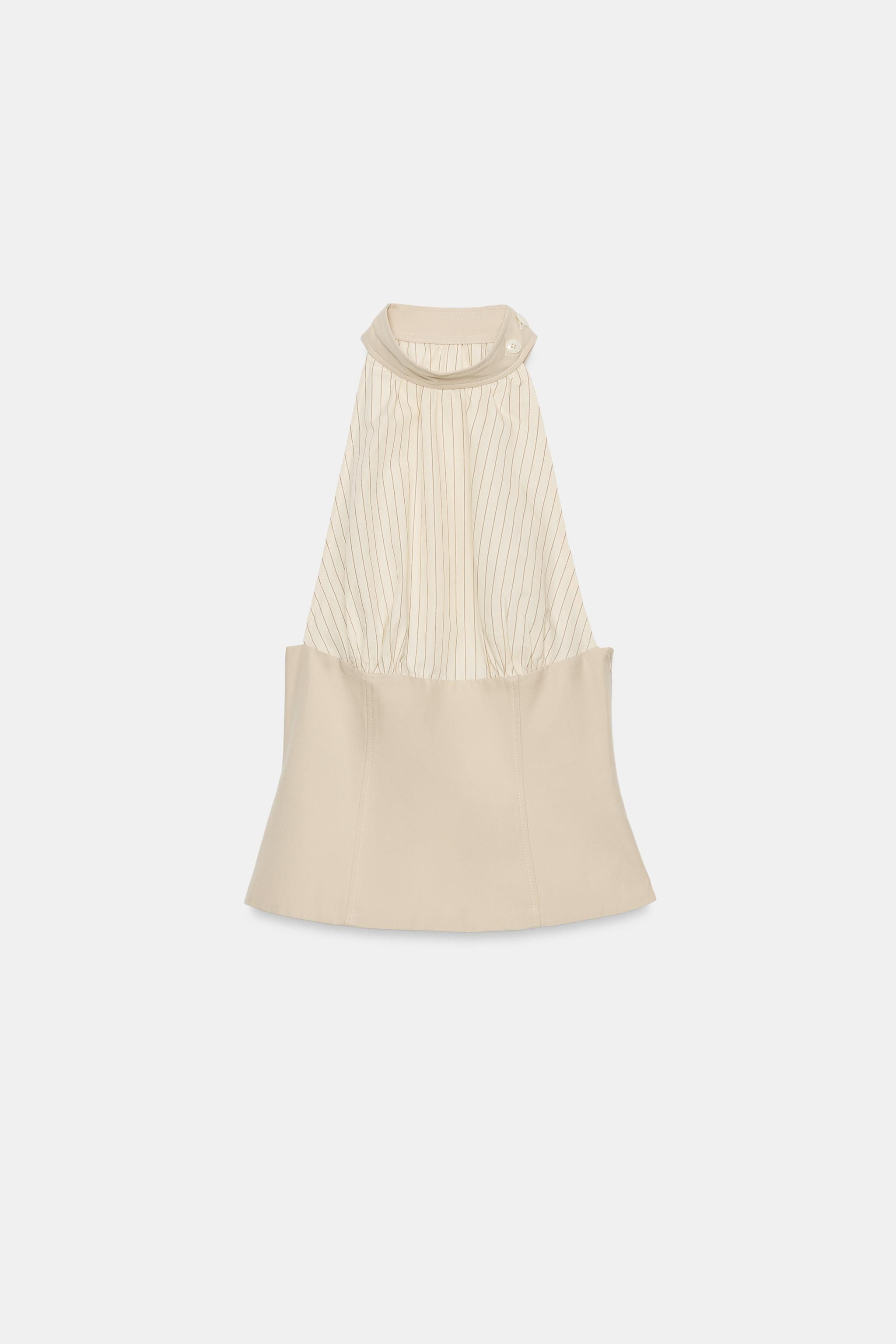 Adjustable high-neck halter top with buttons and cold-shoulder design. Mixed fabric detail. Side ... | Zara US