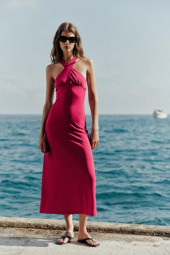 Long dress made from a flowing fabric. V-neckline with wide crossover straps on the front. Flared... | Zara UK