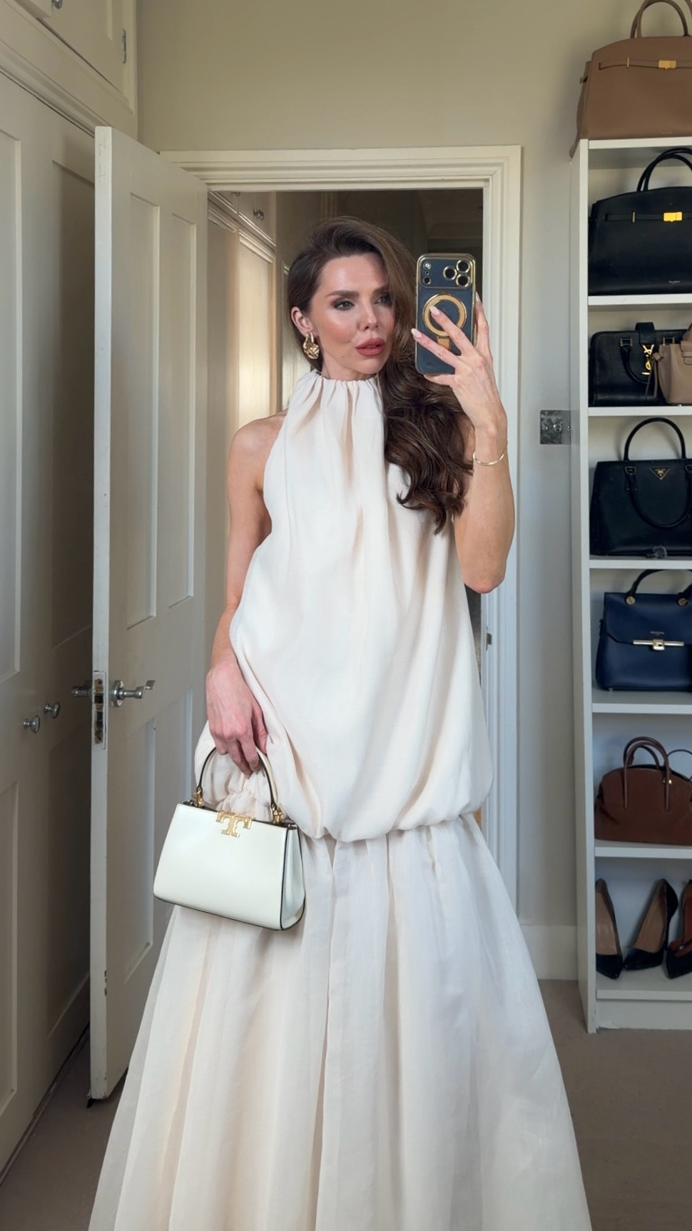 
A soft statement in cream, this pleated organza midi dress plays with volume through its gently ballooned silhouette. The high neckline and sleeveless cut keep the shape clean, while the lightweight fabric adds movement and structure in equal measure. Relaxed yet considered, it feels modern without trying too hard. For reference, I’m 5'4 and usually wear a UK size 6.

#LTKpartywear #LTKwedding #LTKmaternity