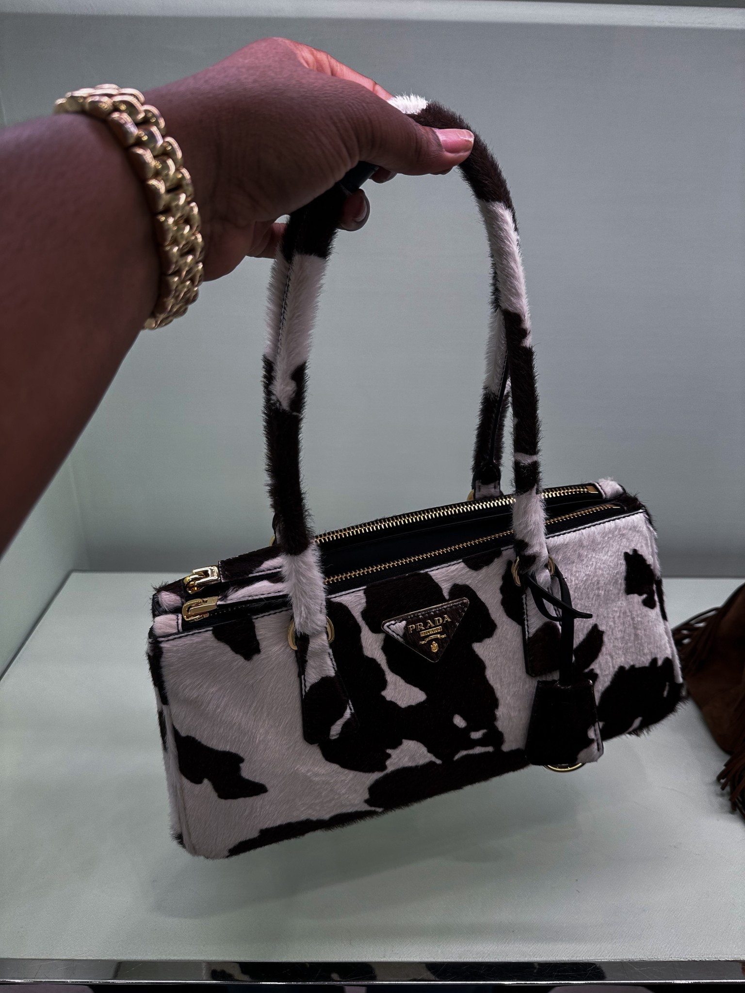 Statement piece of the season 🐄✨ This cowhide Prada mini is the definition of luxury with personality. Linking a look alike + the real deal here on LTK!

#LTKItBag #LTKStyleTip