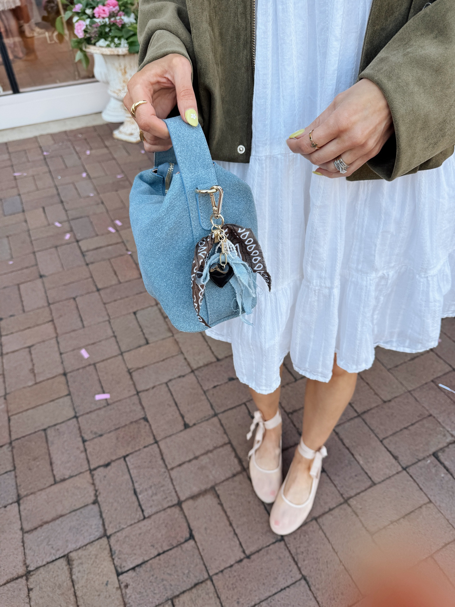 The cutest denim suede bag with bandana bag charm. 