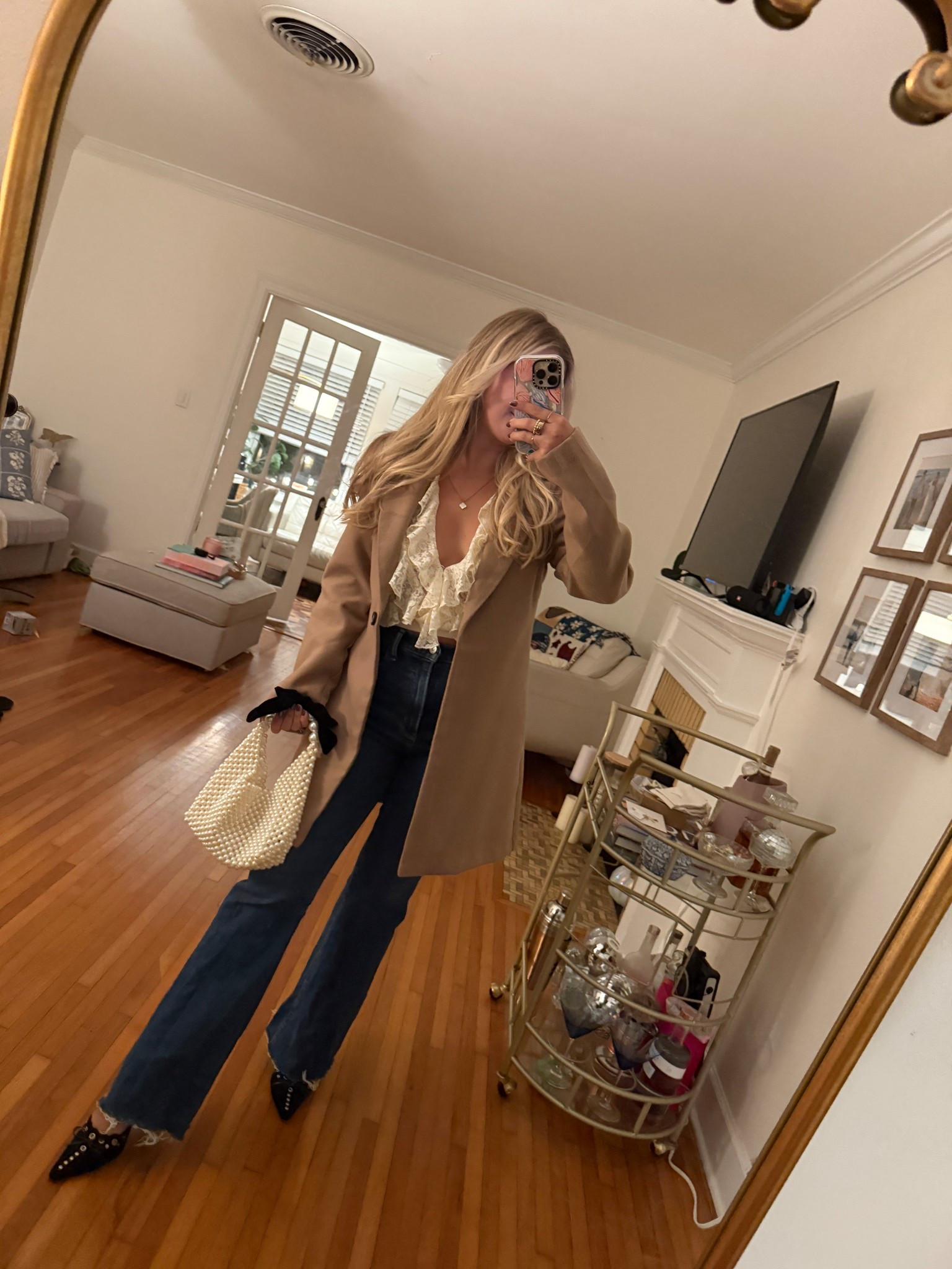 outfit of the night! flare jeans, pearl handbag, kitten heels, ruffle blouse 

#LTKootd #LTKFindsUnder100 #LTKStyleTip