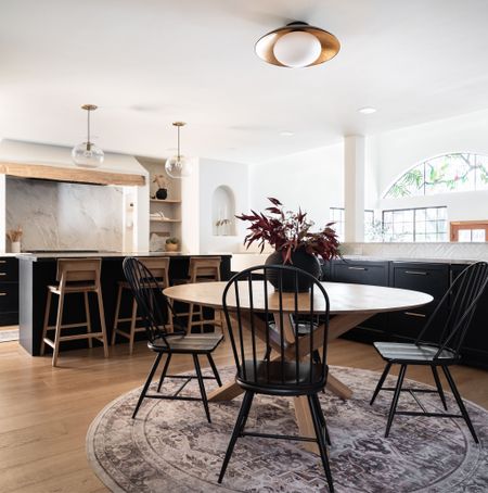 Kitchen with sleek black cabinetry and contrasting two toned counters with natural materials. 

Rug, kitchen table, kitchen chairs, stools, hardware, home decor, runner. 

#LTKunder100 #LTKhome