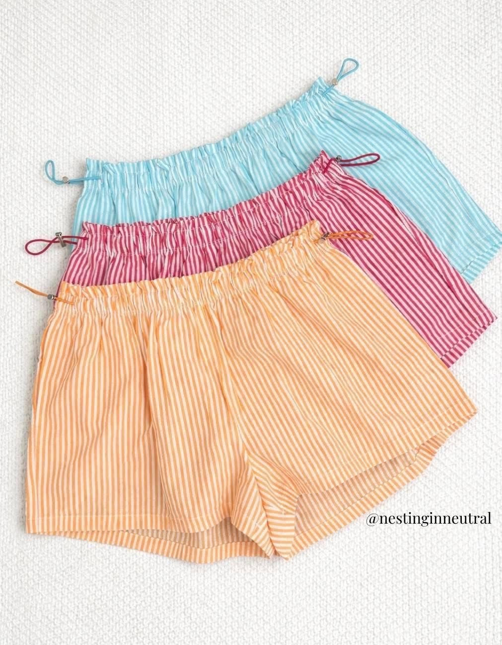 ONLY $9! 😍 All over social media and they WILL sell out so scoop them up in all the colors while you can! The cutest shorts with a bungee cord waist... such a 90's vibe! Your teen girls will love them with fitted tees and I'm wearing them with a graphic tee. 

Summer, shorts, stripes 

#LTKSeasonal #LTKU #LTKActive