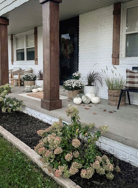 fall porch - mums + grasses this year love the natural combo this makes with my white + rattan planters! + my fav green heirloom pumpkins. my wreath is a dried olive leaf wreath it’s so beautiful for fall I added a brown velvet ribbon knotted and draped down the center 

#LTKSeasonal #LTKfindsunder50 #LTKhome